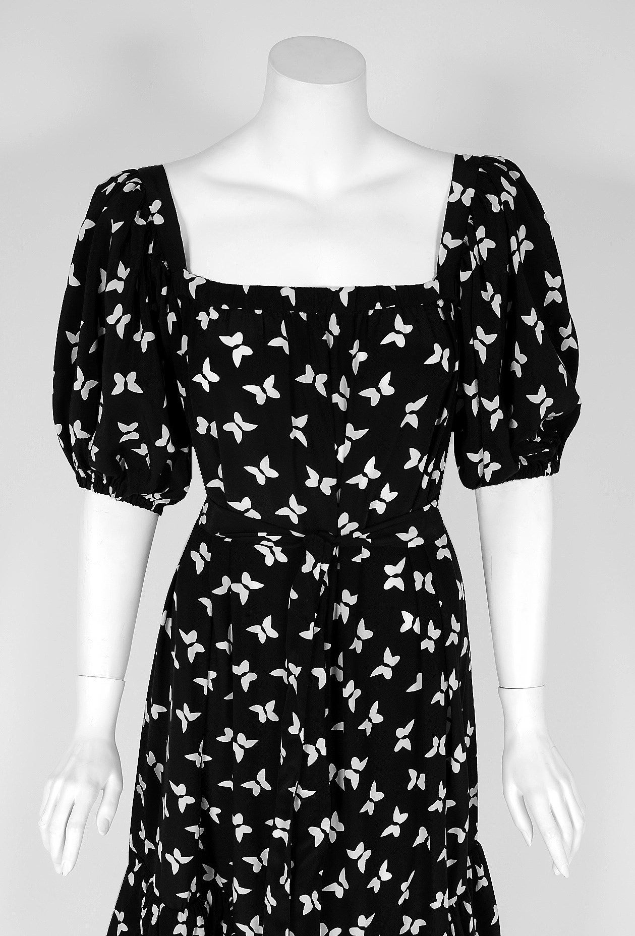 Gorgeous Yves Saint Laurent black and white butterfly novelty-print silk dress from the infamous Rive Gauche collection during the mid-1970's. Pieces from this decade are very rare and are true examples of fashion history. I adore the low-cut plunge