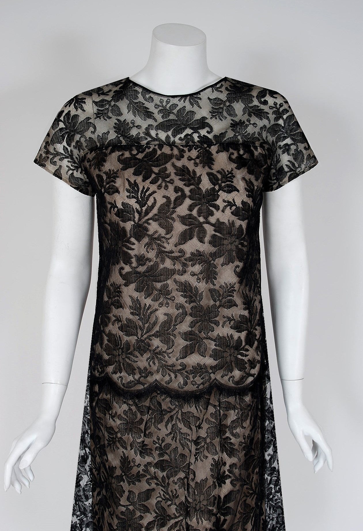 Givenchy, the name itself evokes glamour, refined elegance, simplicity and style. Givenchy's trademark of sculpted lines and luxurious fabrics make his work easily recognizable. This gorgeous black lace cocktail is a beautiful example of his