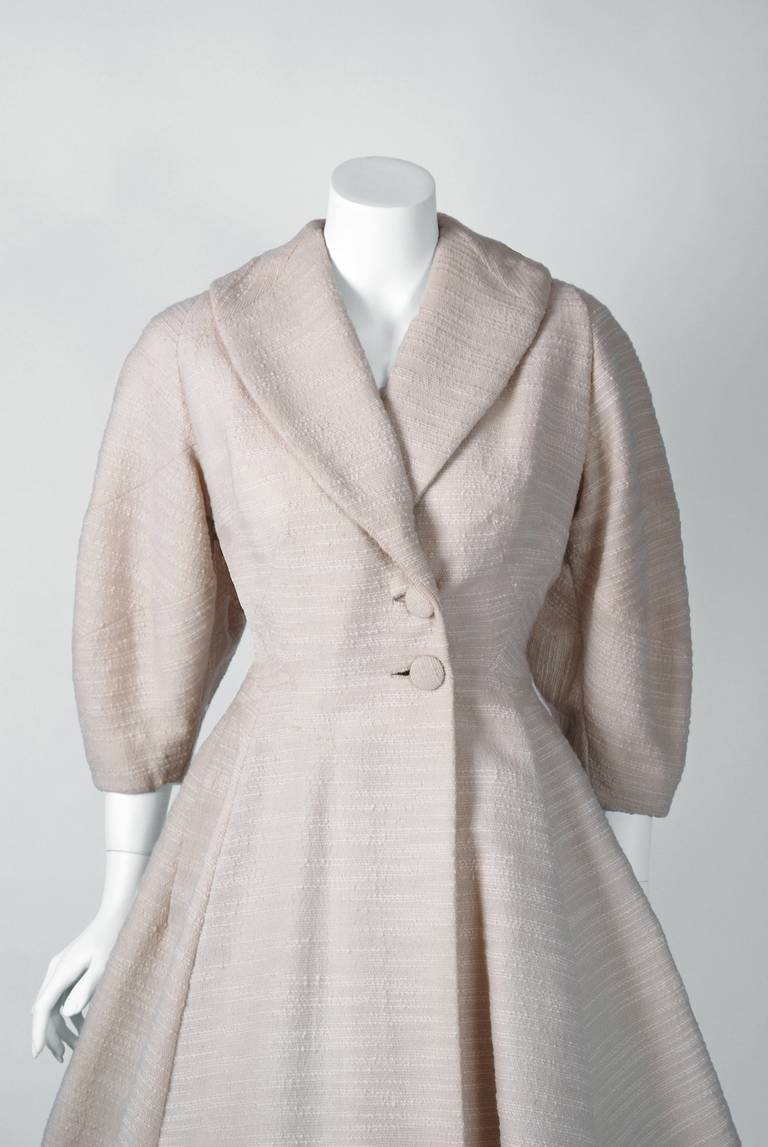 Lilli Ann was started in San Francisco in 1933 by Adolph Schuman, naming his company for his wife, Lillian. The company became known for their beautiful, elaborately designed suits and coats. This stunning garment is fashioned in a rich fully-lined