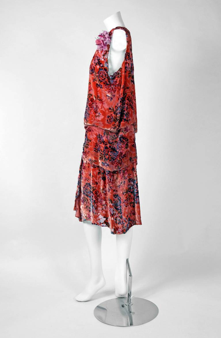 The breathtaking watercolor floral-garden pattern used in this early 1920's cut silk-velvet flapper dress has a fresh innocence that I find irresistible. A unique coral-peach color which also changes to a golden tone in certain light. I love the