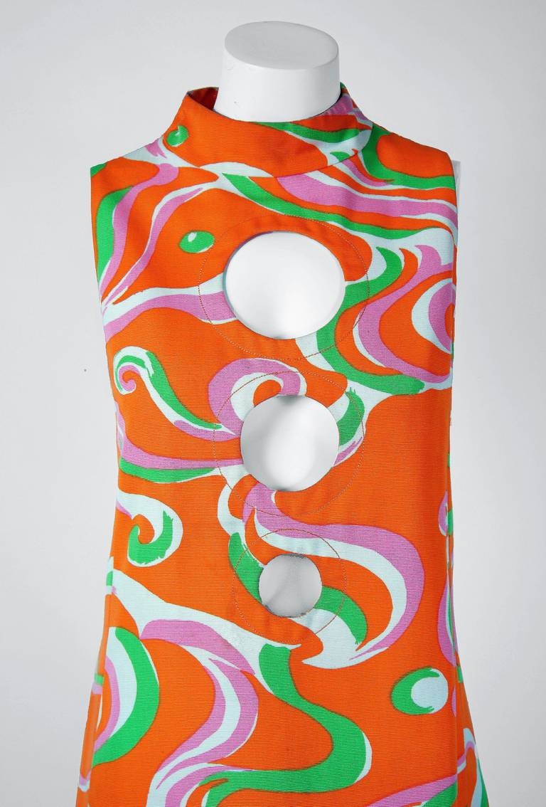 Spectacular mid 1960's Pierre Cardin cotton-twill mini dress in a vibrant psychedelic pattern. In 1951 Cardin opened his own couture house and by 1957, he started a ready-to-wear line; a bold move for a French couturier at the time. The look most