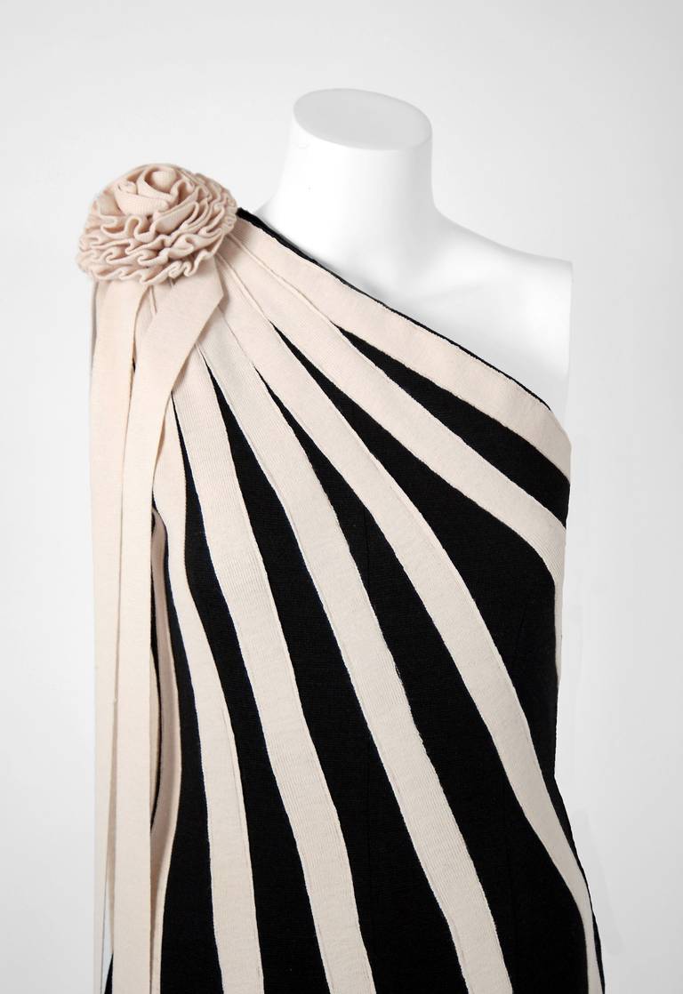 In this gorgeous 1960's black & ivory abstract stripe gown, the detailed construction and meticulous attention to detail are comparable to what you will find in modern haute-couture. This enchanting garment is fashioned from rich stretch wool-knit