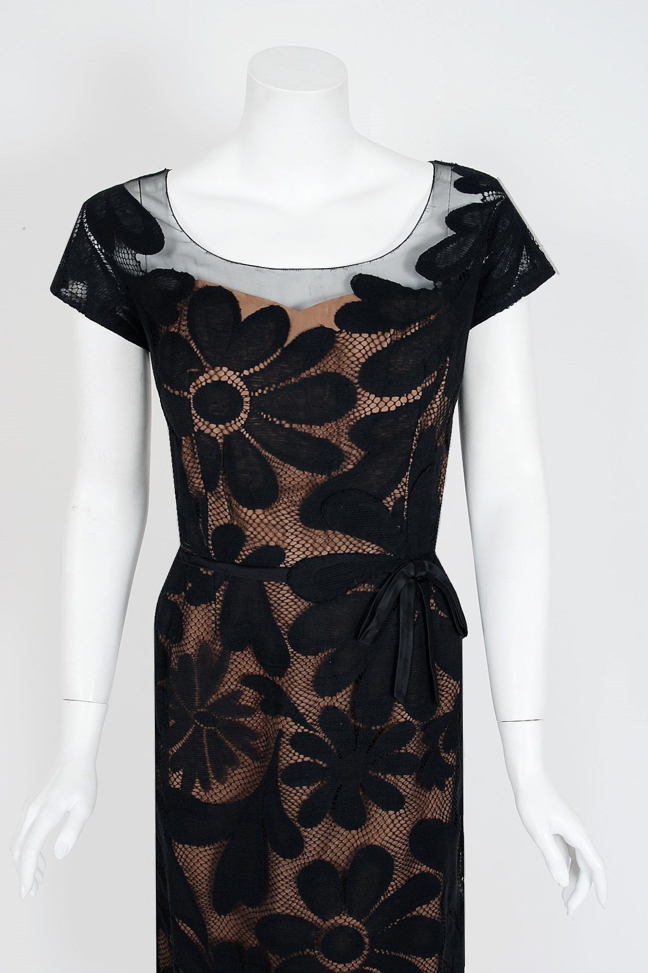An amazing and highly stylized 1950's cocktail dress by the famous American designer Peggy Hunt. Starting in the 1930's through the early 1960's, she was immensely successful with her specialized cocktail and evening dresses. Her garments were often