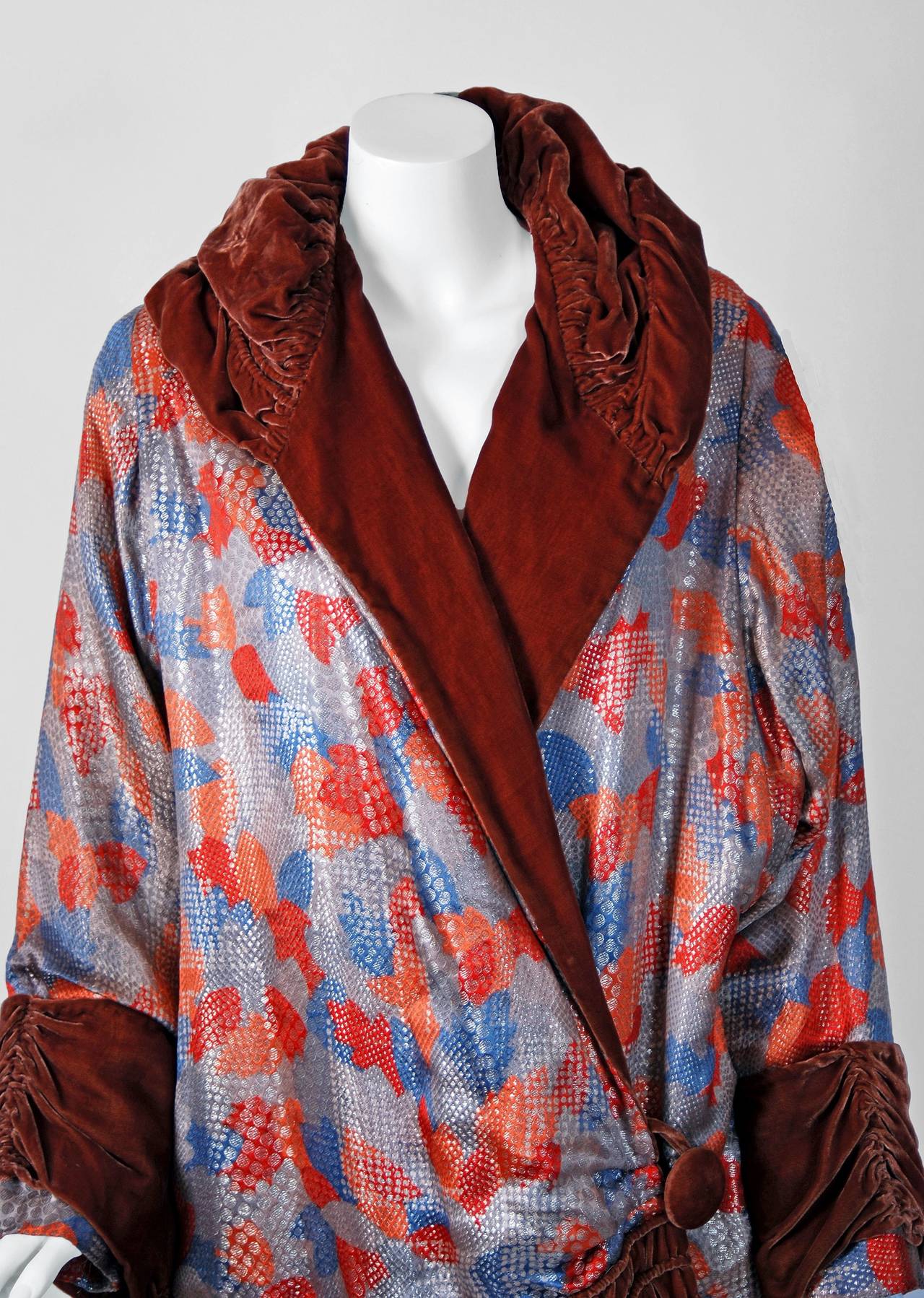 This breathtaking and unbelievable French metallic art-deco patterned lame & cinnamon silk-velvet coat will make any woman shine during the upcoming winter months.  The metallic shimmer adds a perfect amount of sparkle to this luxury treasure. I