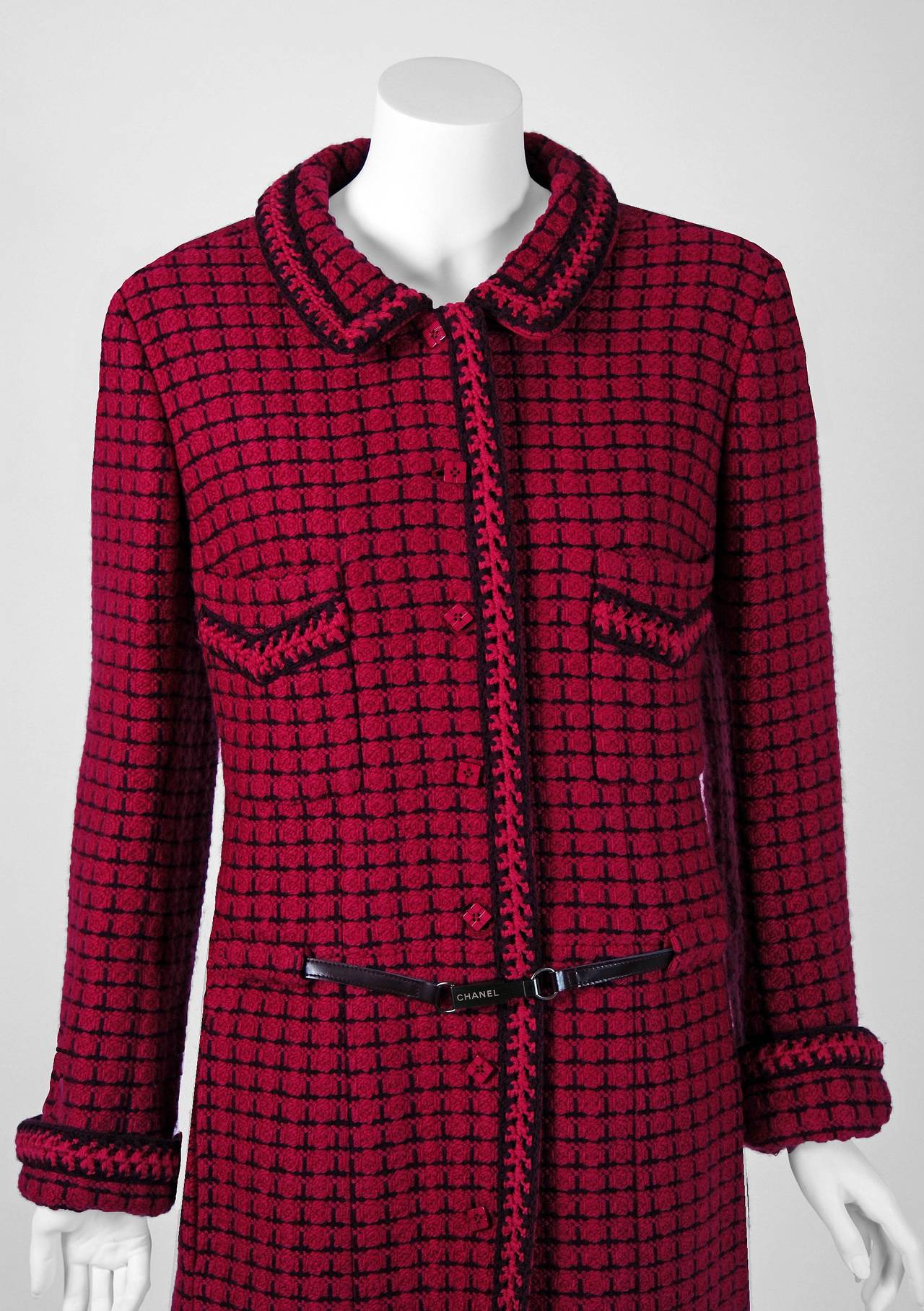 Chanel is known to be one of the most luxurious and decadent fashion houses in the world. This breathtaking raspberry & black plaid boucle-wool coat is a perfect example of why this couture brand has stood the test of time. Not only is this little