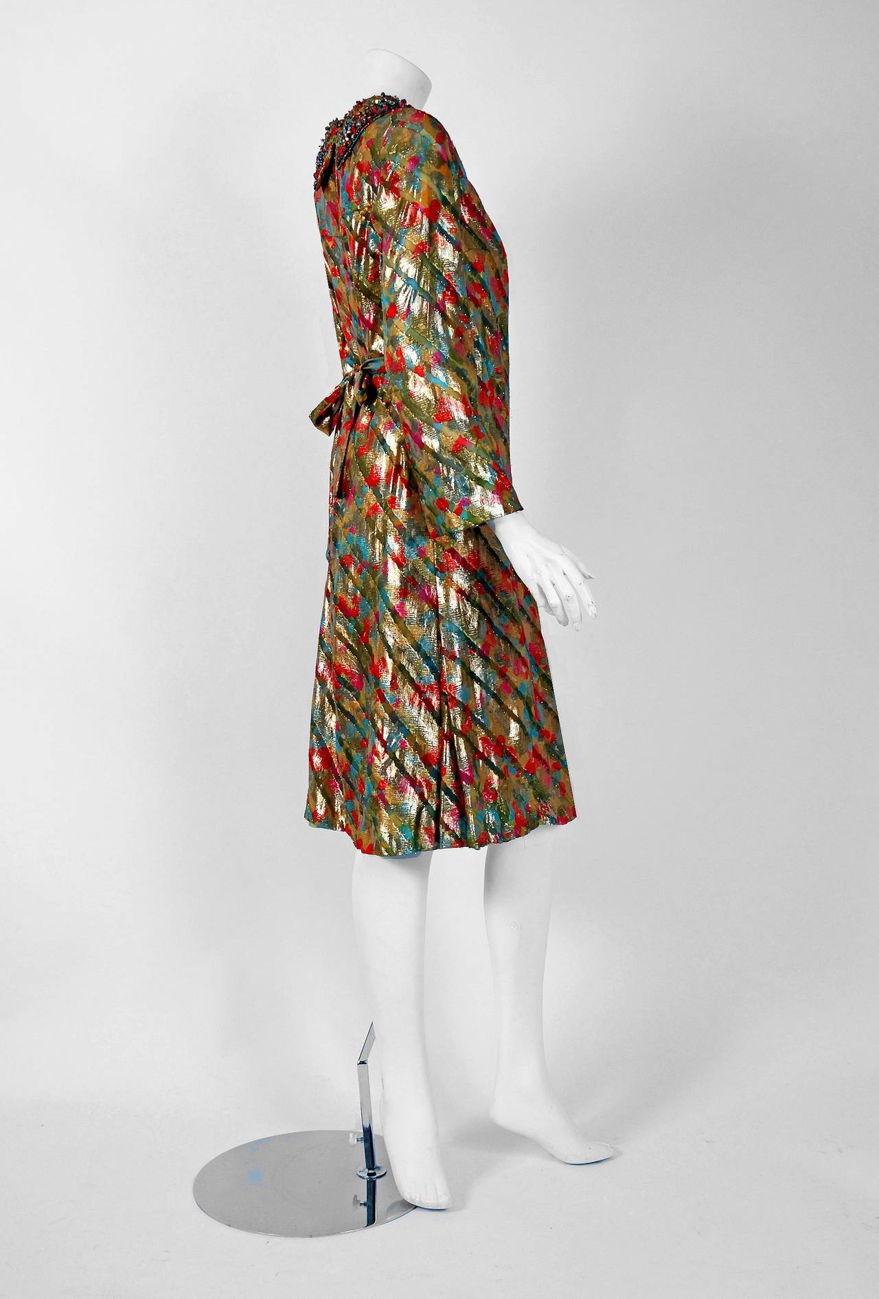 Truly a wonderful designer colorful lame silk cocktail dress by Branell. I think this is one of the best examples of 1960's mod glamour chic fashion I have seen in a long time. The design was obviously inspired by Courreges and Cardin who were the