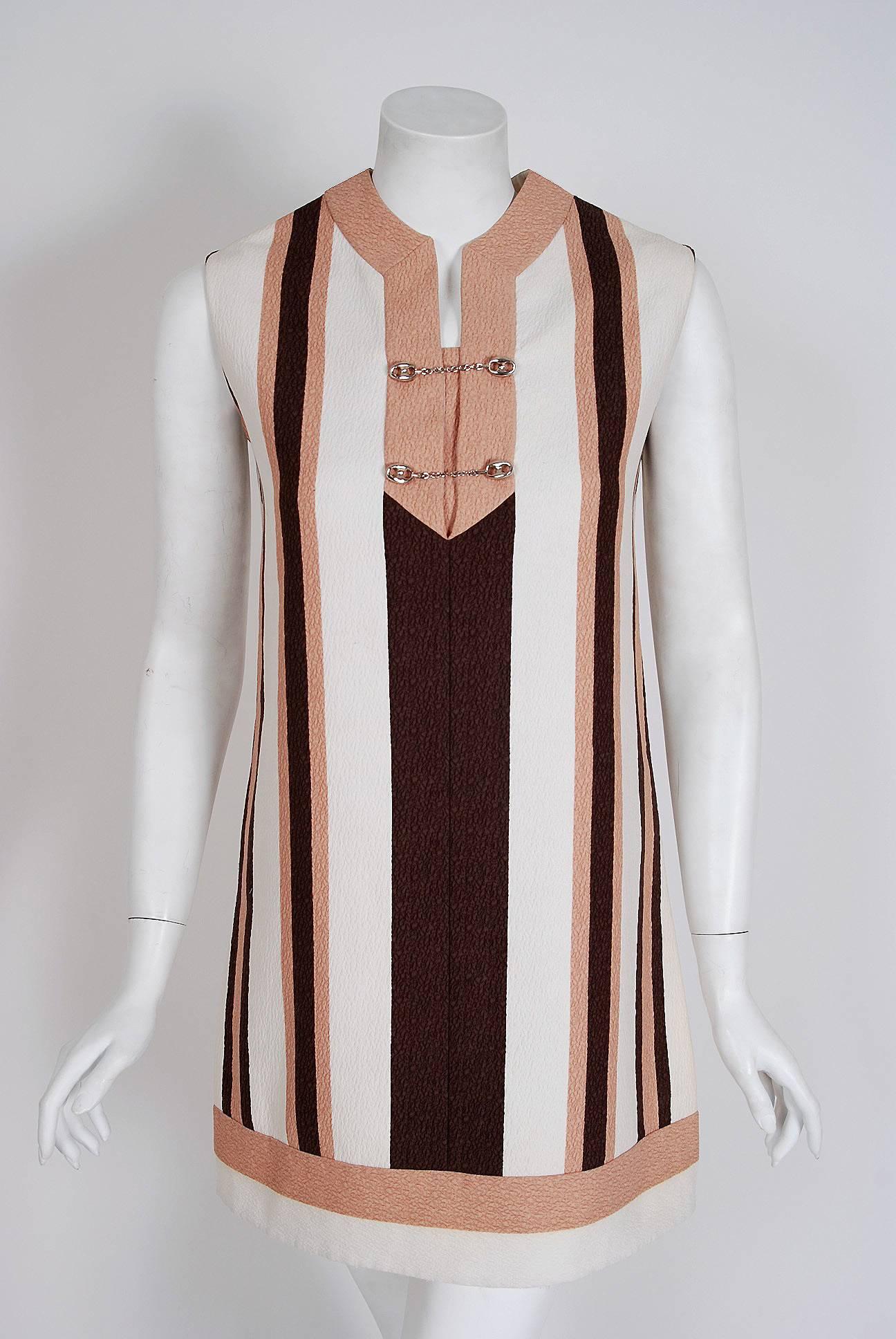 Earlier Gucci garments are very hard to come by and this mini dress is breathtaking! Perfect for any upcoming event; you can't help but feel ultra chic in this couture beauty. The dress is fashioned from fully-lined ivory, pink and brown striped