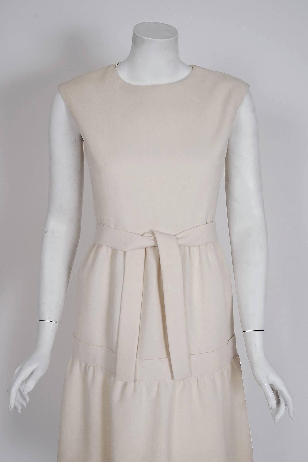 Spectacular mid 1960's Pierre Cardin designer dress in a rich ivory-white tailored wool. In 1951 Cardin opened his own couture house and by 1957, he started a ready-to-wear line; a bold move for a French couturier at the time. The look most