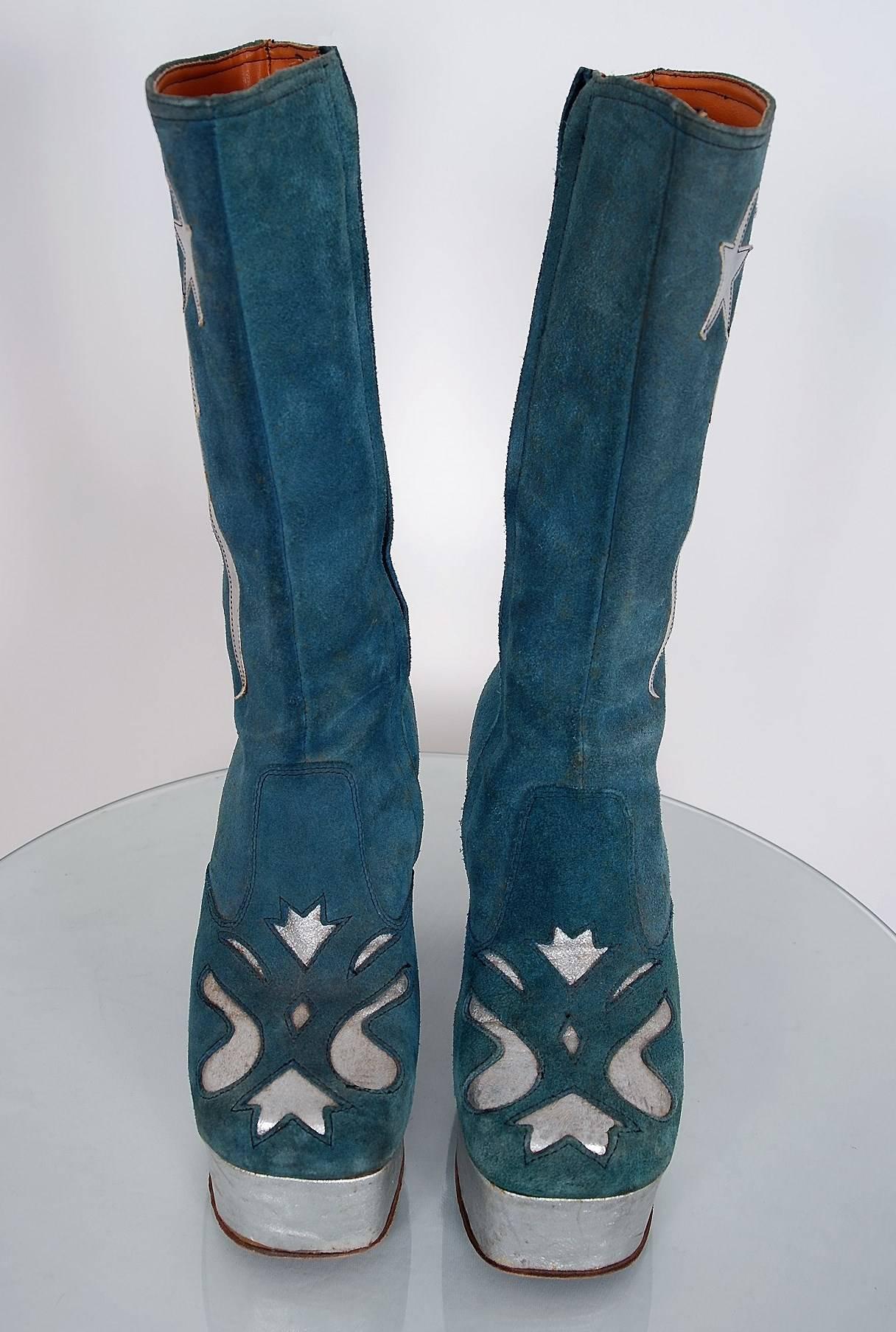 Amazing 1970's British custom-made leather boots in the most incredible turquoise-blue and silver color combination. These boots have stacked wood-heels with a leather-covered high platform. I love the detailed novelty lightning-bolt and stars