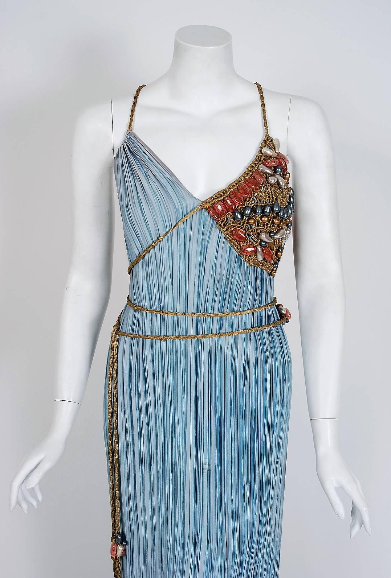Breathtaking Mary McFadden Couture sky-blue goddess gown dating back to the late 1970's. McFadden designed with a relative unconcern for fashion trends. Instead, she used her talent as a way to explore her personal interests: visual art and the