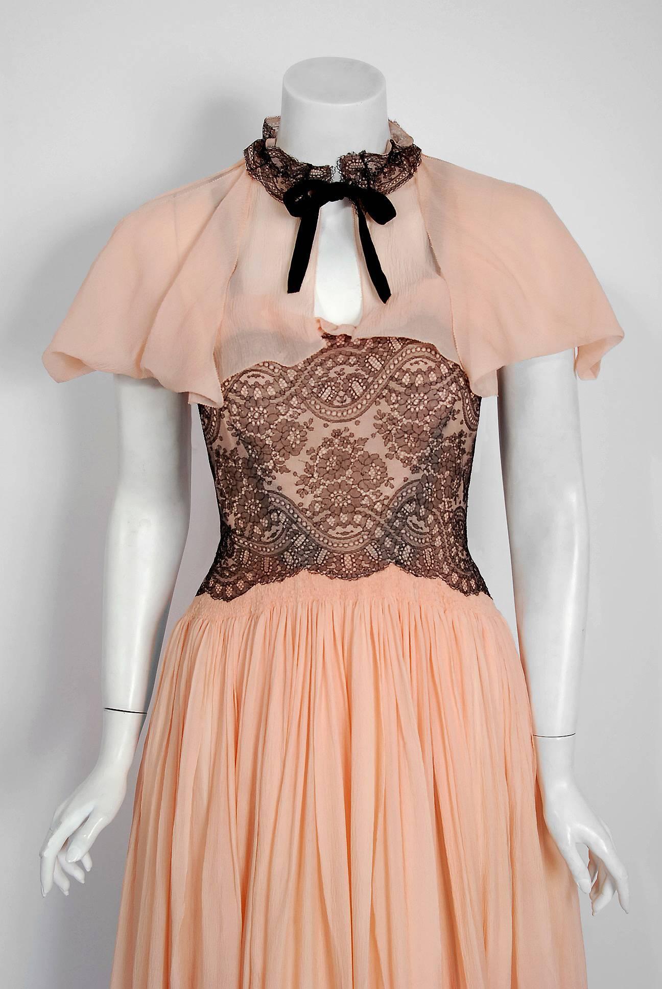 The breathtaking 1940's light pink silk-chiffon and black chantilly-lace used for this French couture ensemble has an ethereal quality that I find irresistible. The boned bodice has elegant ruffle trim with smocked scalloped shaping. From such