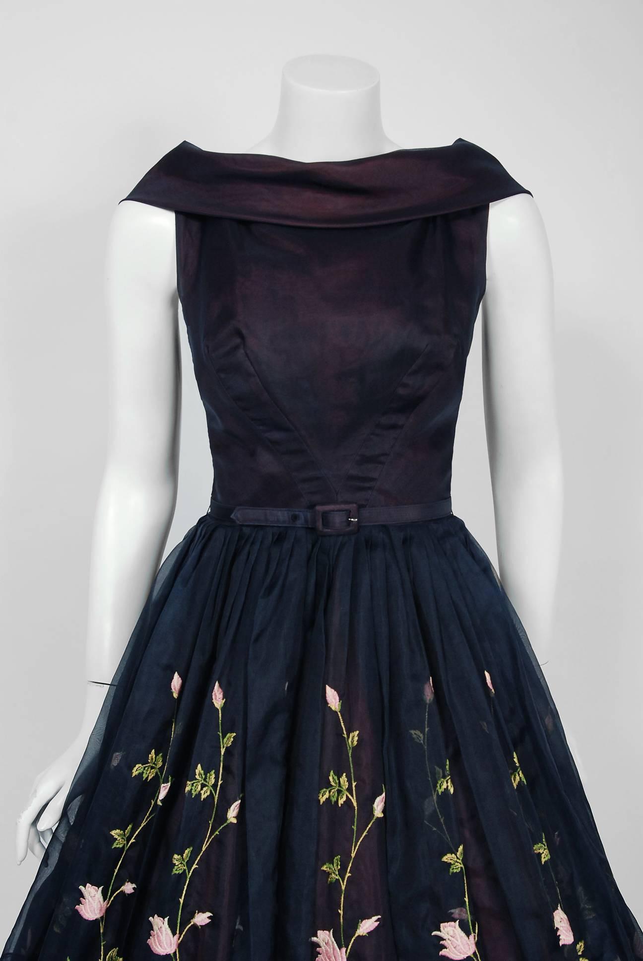 This Claudia Young designer show-stopper is one of the most alluring and flattering 1950's garden party dresses I have ever seen. Fashioned from iridescent navy-blue embroidered silk organza, this creation has everything a woman wants. The bodice