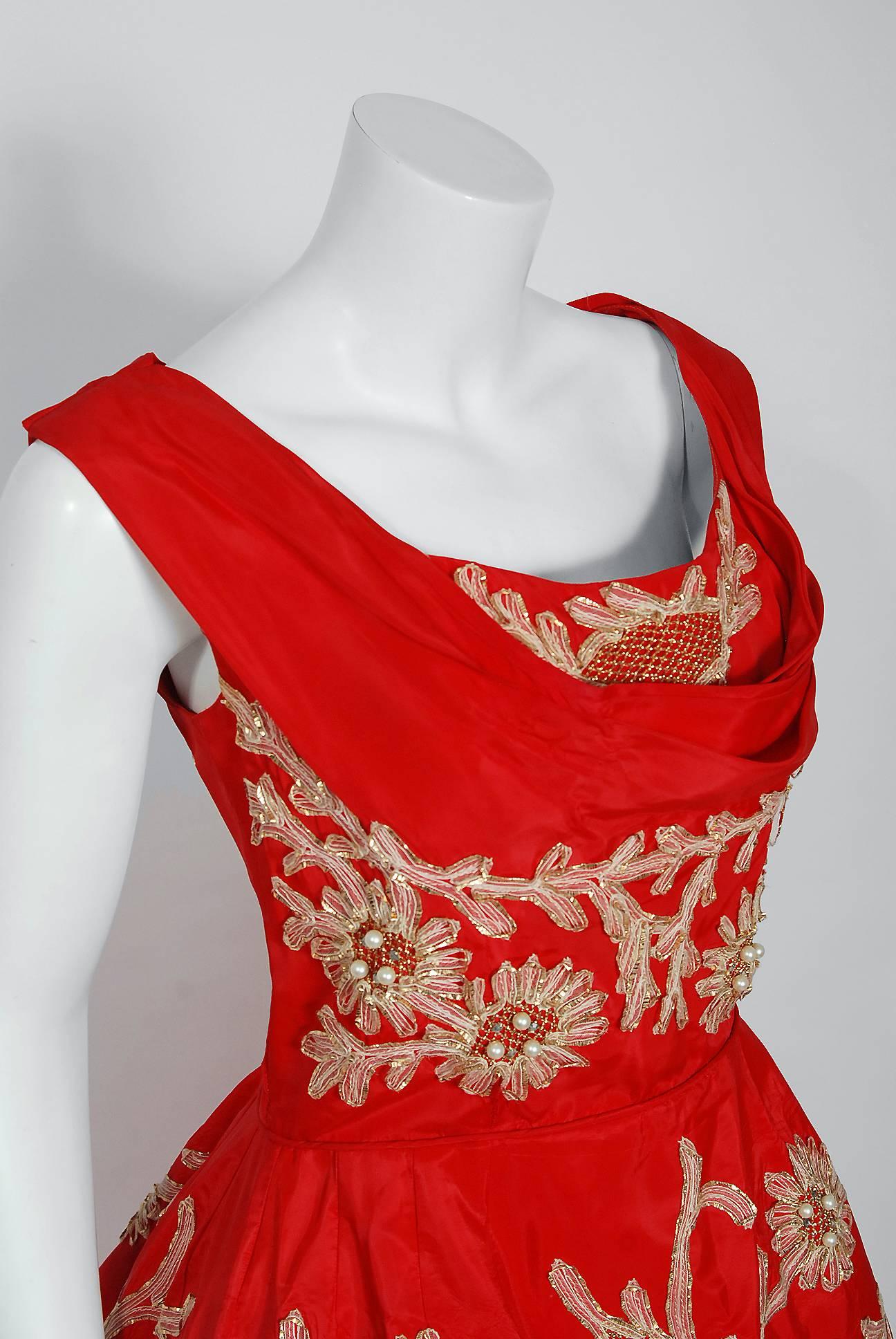 This is such a dramatic and romantic 1950's party dress from the Miss Smart American designer label. Perfect for any upcoming party; you can't help but feel feminine in this beauty! The garment is fashioned from a stunning ruby red taffeta with