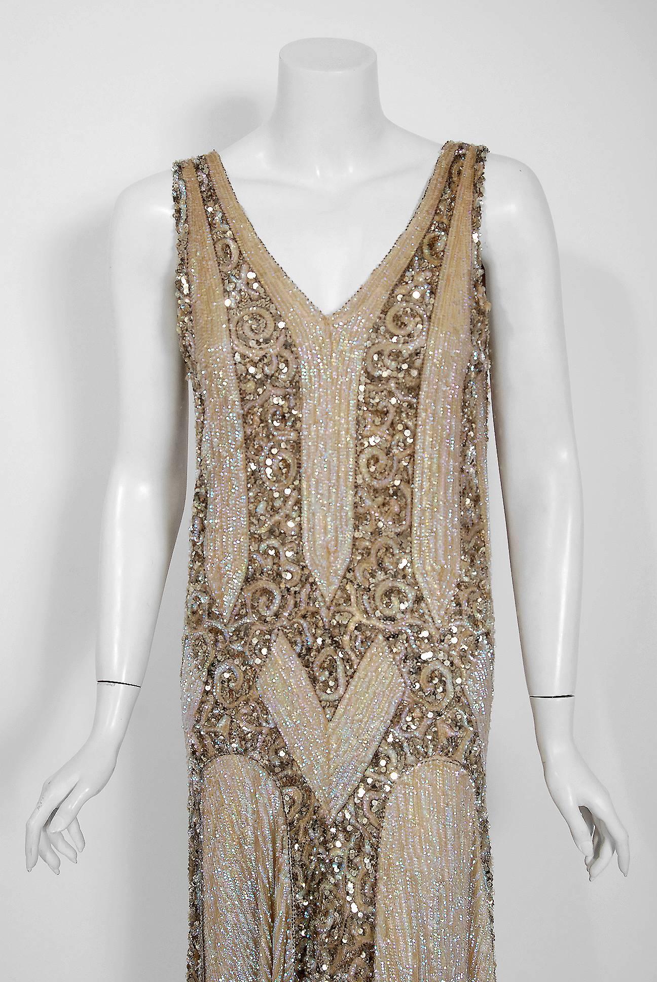 Breathtaking 1920's French museum quality sparkling net-tulle flapper dance dress. The champagne golden color palette touches a deep chord in our collective aesthetic consciousness. As fashion lovers, we never tire from antique beadwork; it will