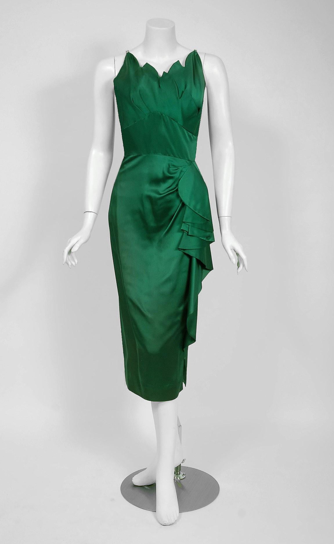 A seductive Andrée Gay designer forest-green silk cocktail set dating back to the 1940's Old Hollywood era of glamour! The bodice is an alluring rhinestone strap low-cut sculpted plunge to resemble fire flames. The nipped waist sculpted side peplum