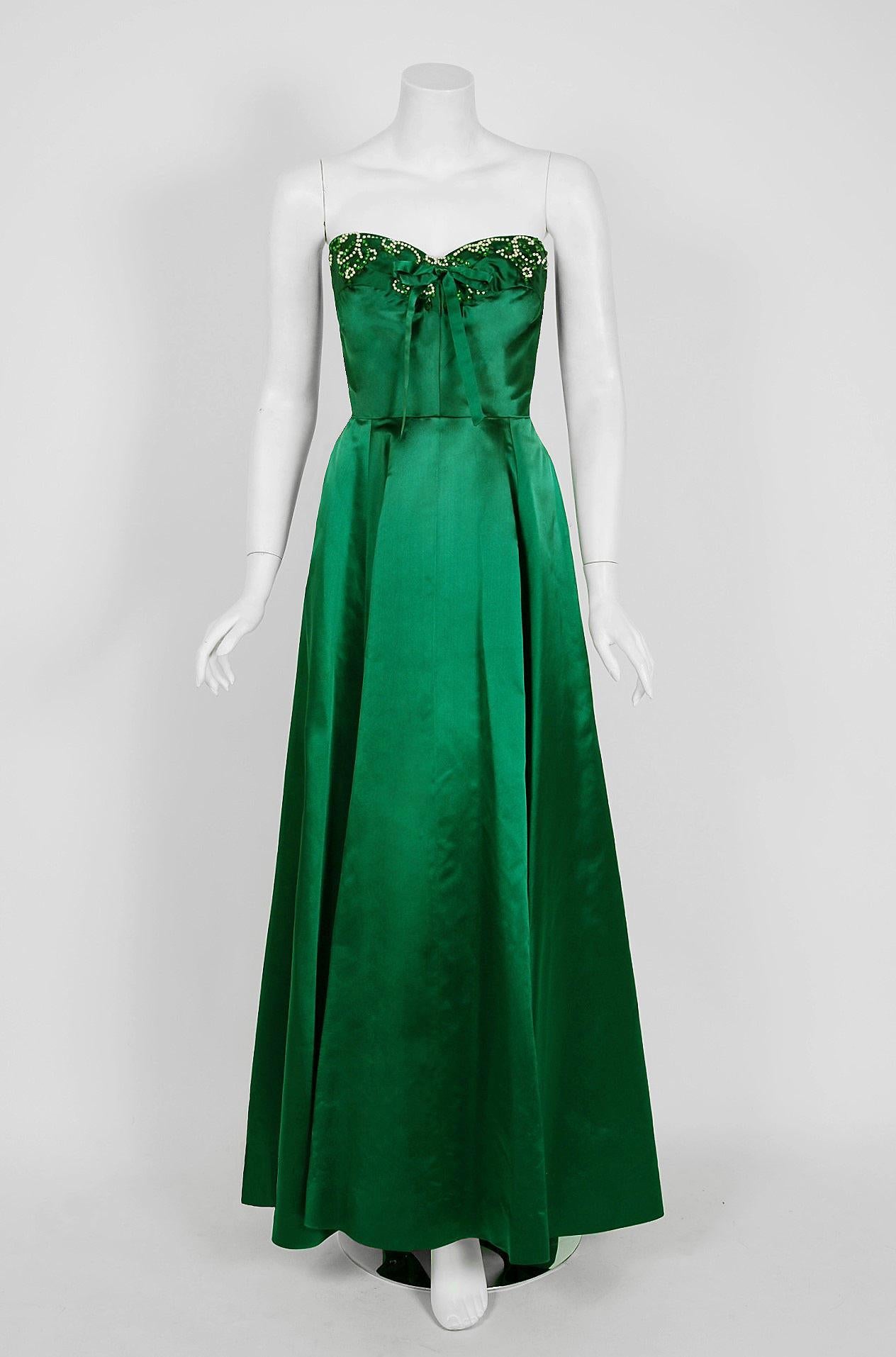 In this gorgeous 1950's Helga designer gown, the detailed construction and meticulous attention to detail are comparable to what you will find in modern couture. Helga was established in 1947 by Robert Oppenheimer and his wife Helga Kallman