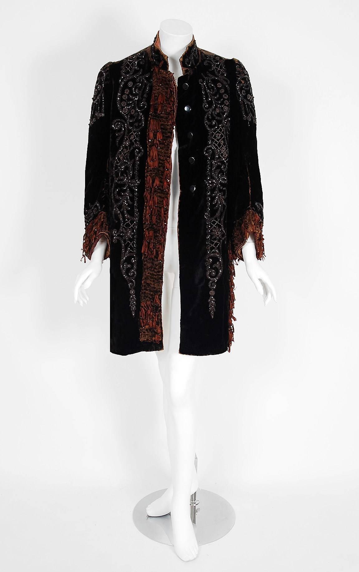 This dazzling custom-made Victorian Couture mantle jacket is lavishly embellished with sparkling jet-beads and silk-chenille fringe. The highly stylized beadwork perfectly captures the Art Nouveau aesthetic, then at a peak of popularity. Rich