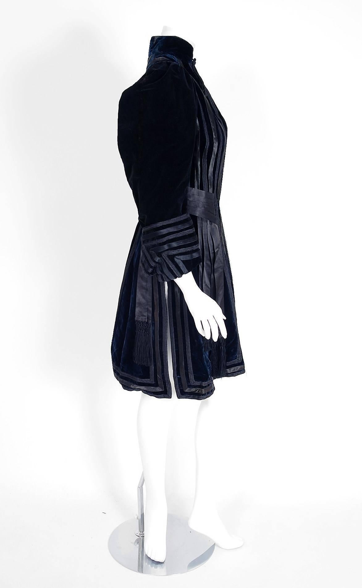 This sensational custom-made Edwardian Couture princess coat is lavishly embellished with stripes of black silk-satin throughout. The highly stylized applique work perfectly captures the Art Nouveau aesthetic. Rich midnight-blue velvet is the base