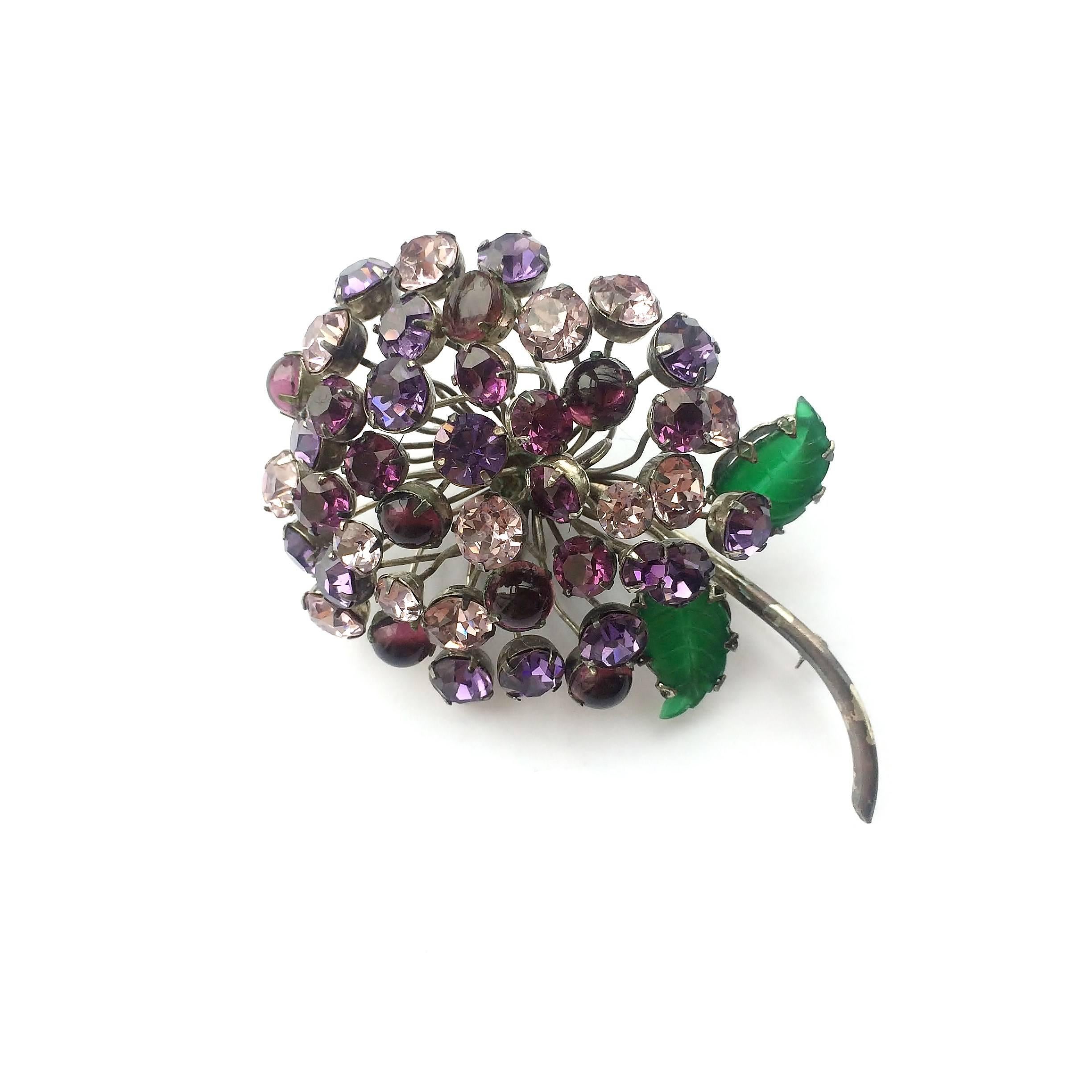 An exceptionally beautiful brooch in the form of a fully blown flowerhead by CIS, very typical, and with a ravishing colour combination. Though unsigned, this is undoubtedly CIS, displaying all her chararcteristics.With pressed glass 'leaves' and