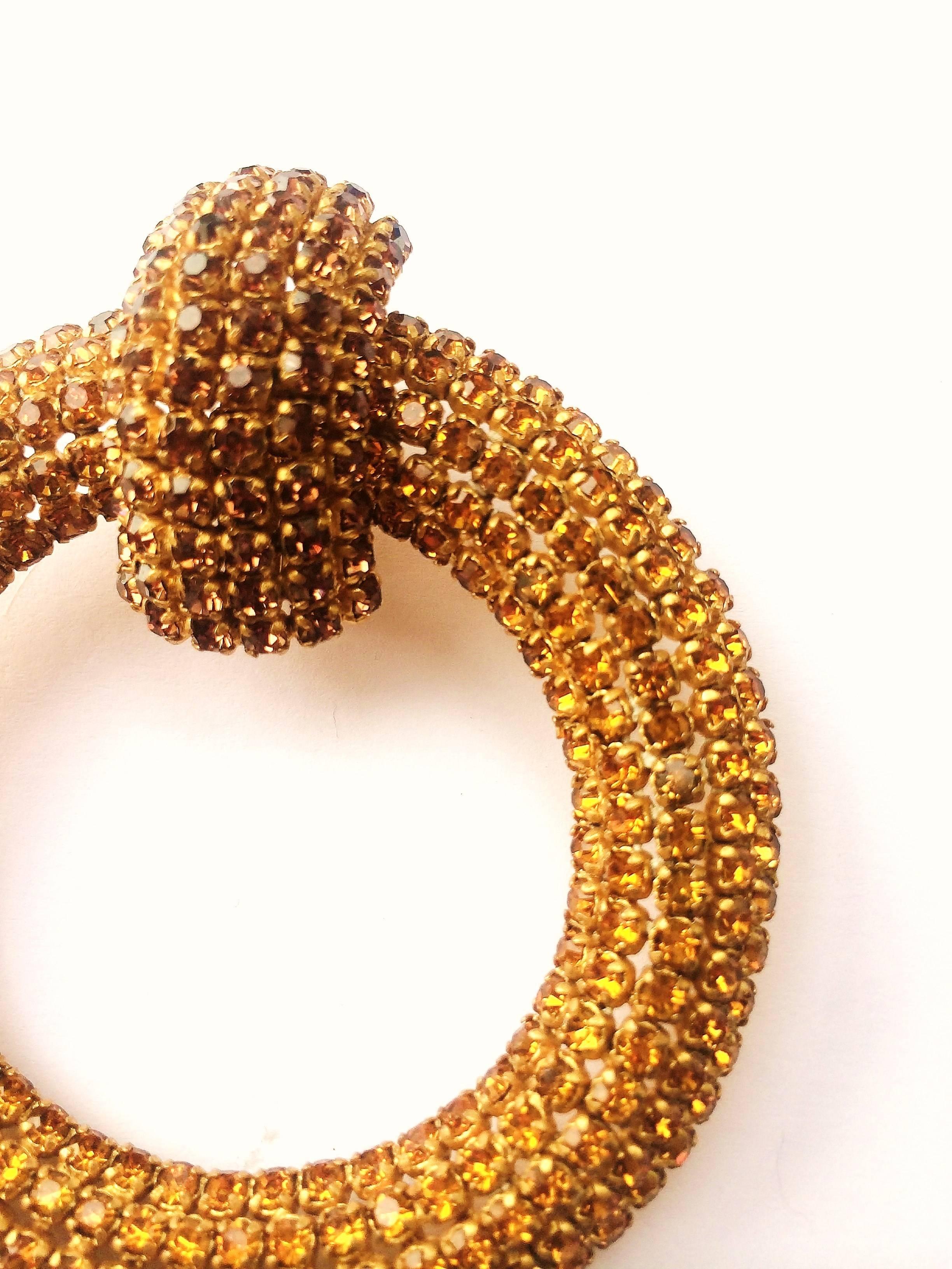 Very stylish and highly typical of the Roger Jean - Pierre haute couture style, with closely set beautifully warm, golden pastes that light up the face, highly unusual but typical of the French haute couture of this period, these 'hoop' earrings