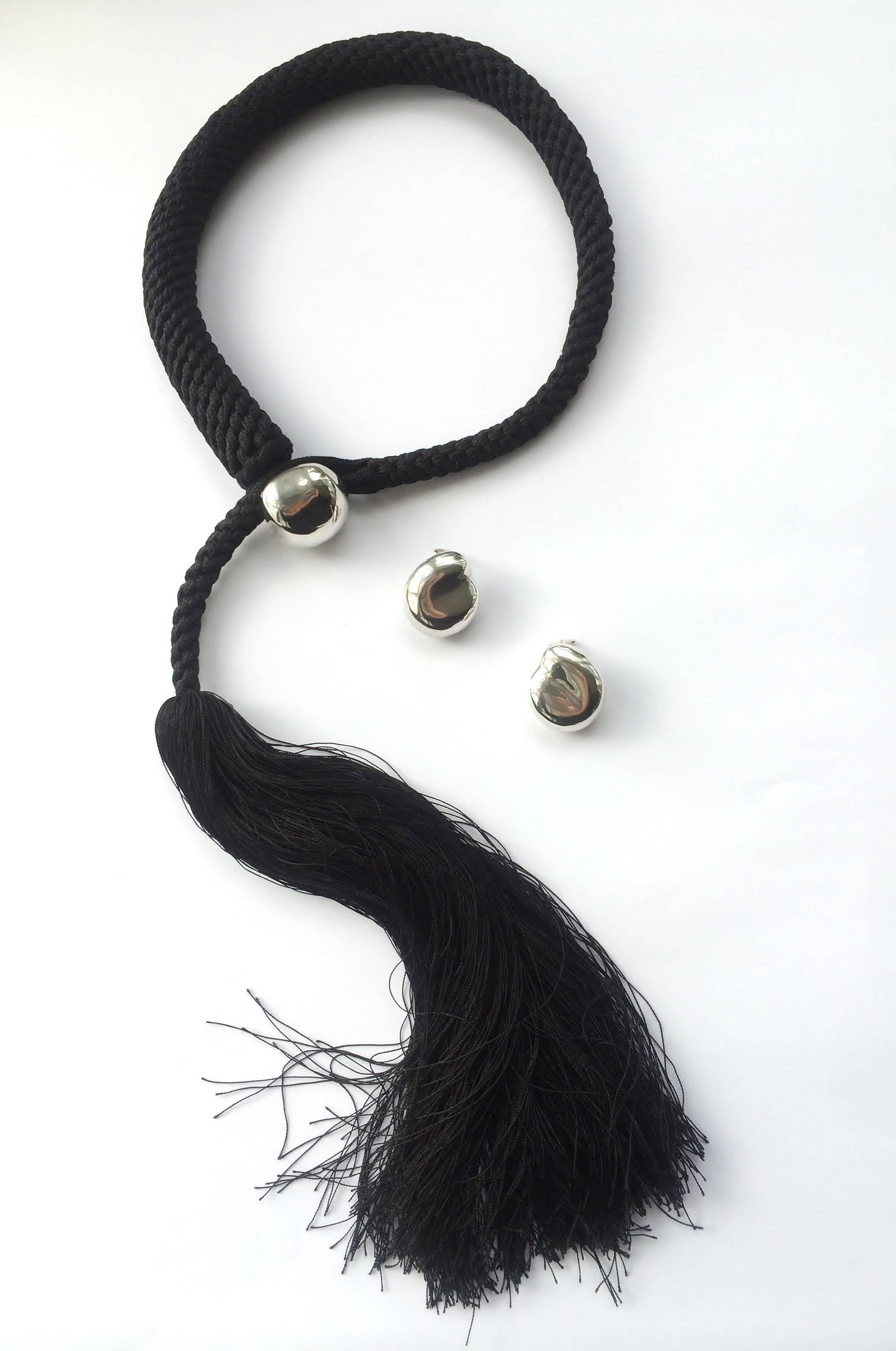 This elegant  'lariatt' style tassle necklace in woven silk and sterling silver, by Tiffany & Co, designed by famous house designer Elsa Peretti, in 1981, comes with matching 'bean' earrings, also in sterling silver. Both necklace and earrings are