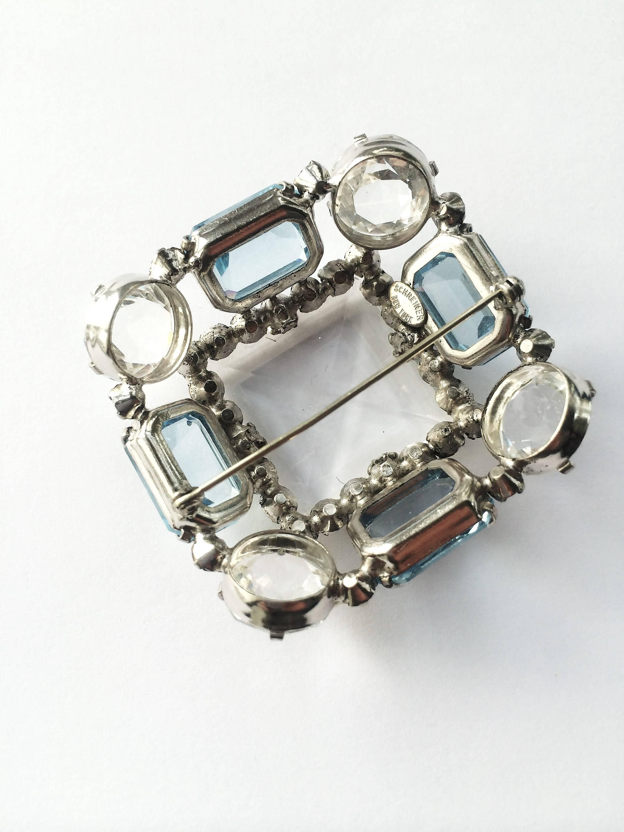 There is something madly princessy about this fantastic 1950s brooch.

Using Schreiner's signature upside down stone technique, this piece glitters and shimmers away reflecting the colours of everything around it. The central glass 'stone' is 1