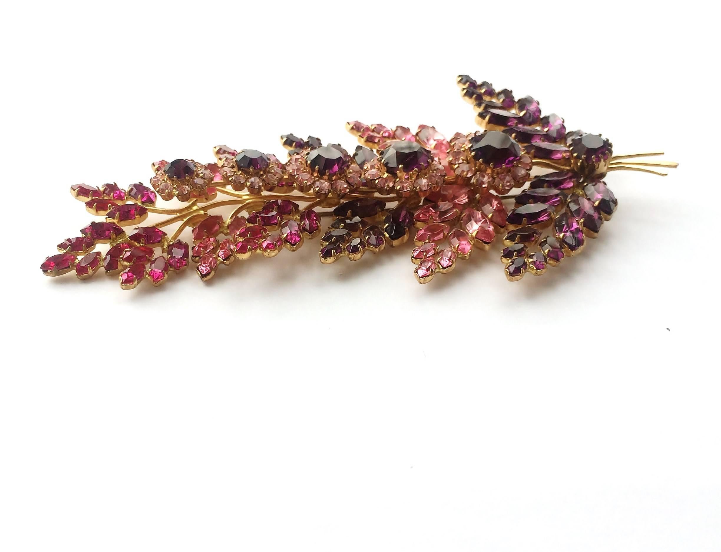 This ravishing very large brooch is made from highest quality Austrian pastes, in amethyst, pale pink and a vibrant, 'shocking' pink colours, set in a soft gold setting. The 'flowers' are placed above the 'leaves' on a seperate 'stem', making it