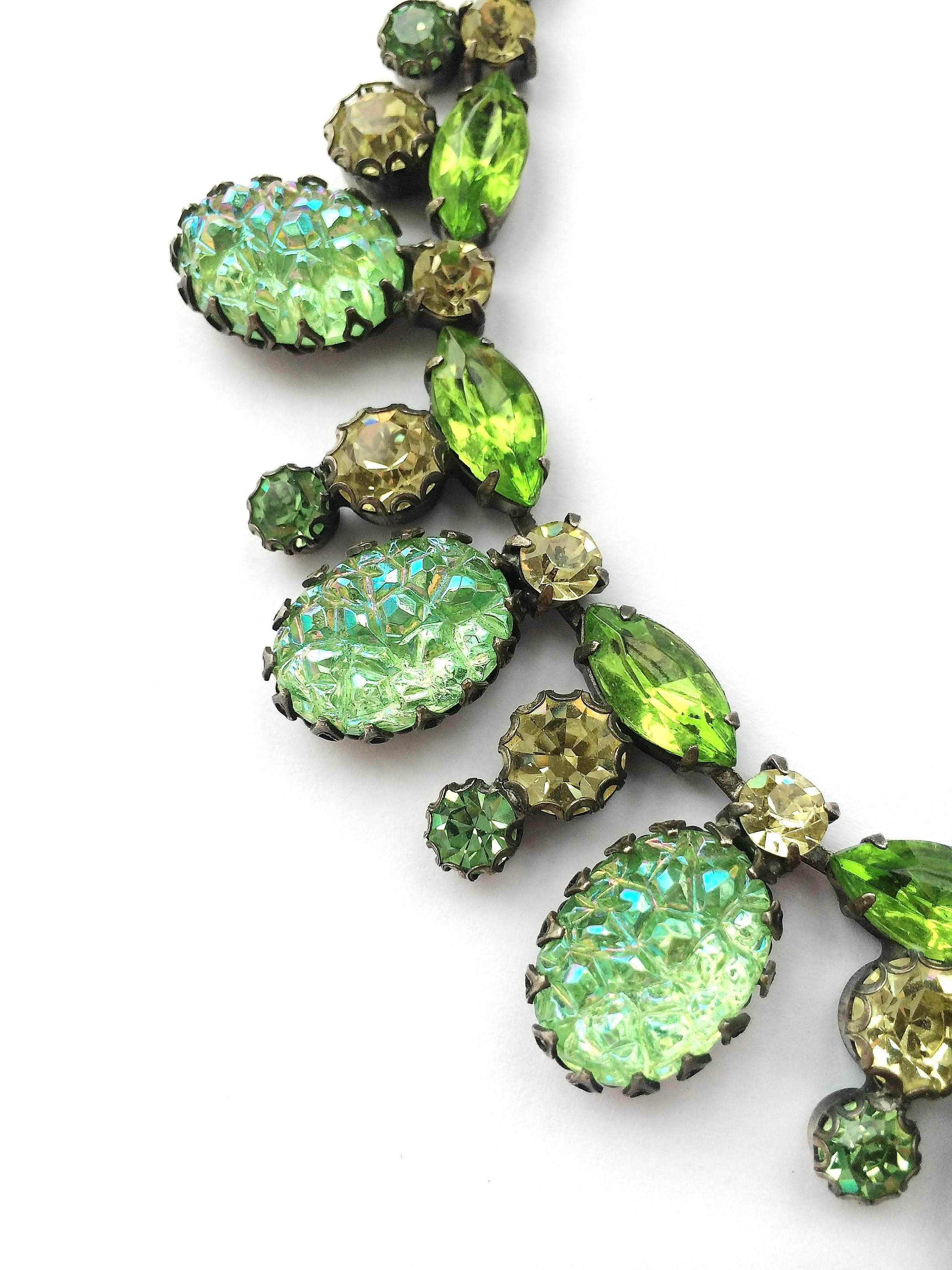 An elegant 3 piece parure from Schiaparelli in the 1950s, using her famous crumpled 'lava' stones in the suite, in a vivid and striking green,perfect for Spring or summer. Either worn as a whole or as an individual necklace, brooch or earring,this
