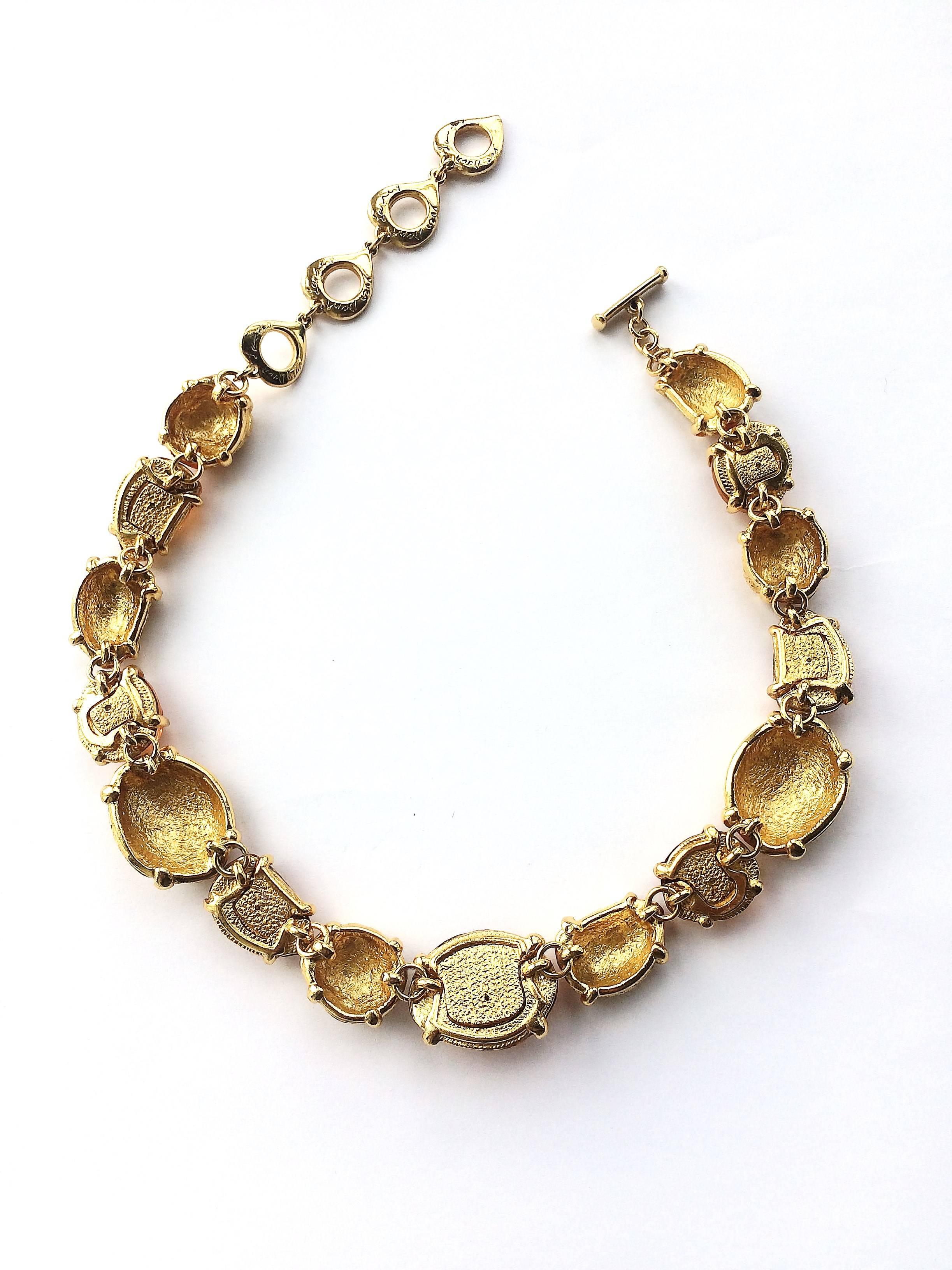 A beautiful and warming necklace from Yves Saint Laurent, with topaz 'nuggets' and textured gilt 'nuggets' of varying shapes and sizes,, alternatively placed around the neckline. With the signature signed 'heart' clasp/fitting, this is a piece of