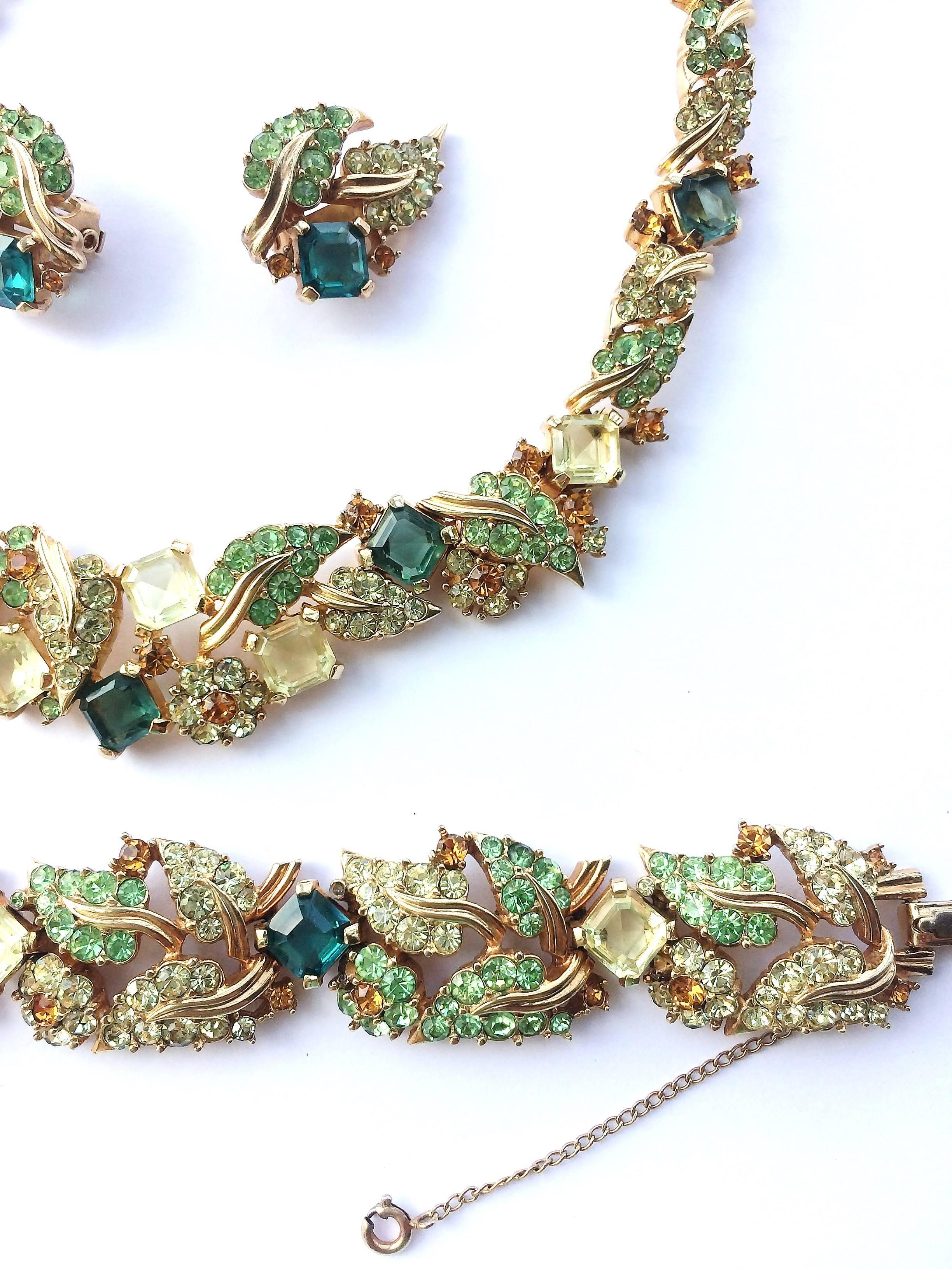 Beautifully designed - a rare necklace, bracelet and earrings from Marcel Boucher, a gorgeous mixture of square stones, and leaf motifs in soft peridot ,citrine, topaz, and emerald paste. Worn altogether or as individual pieces, this set is