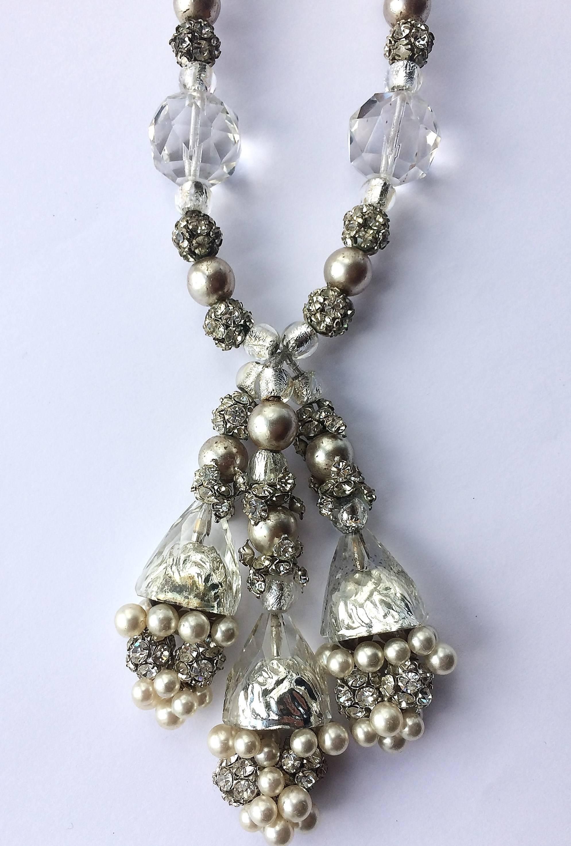 Striking clear glass, silver foiled glass beads, cream pearl and paste ball sautoir necklace, with an adjustable hook/closure. With assorted sizes and shape of bead, the necklace has a triple drop , consisting of silver foiled glass 'caps and