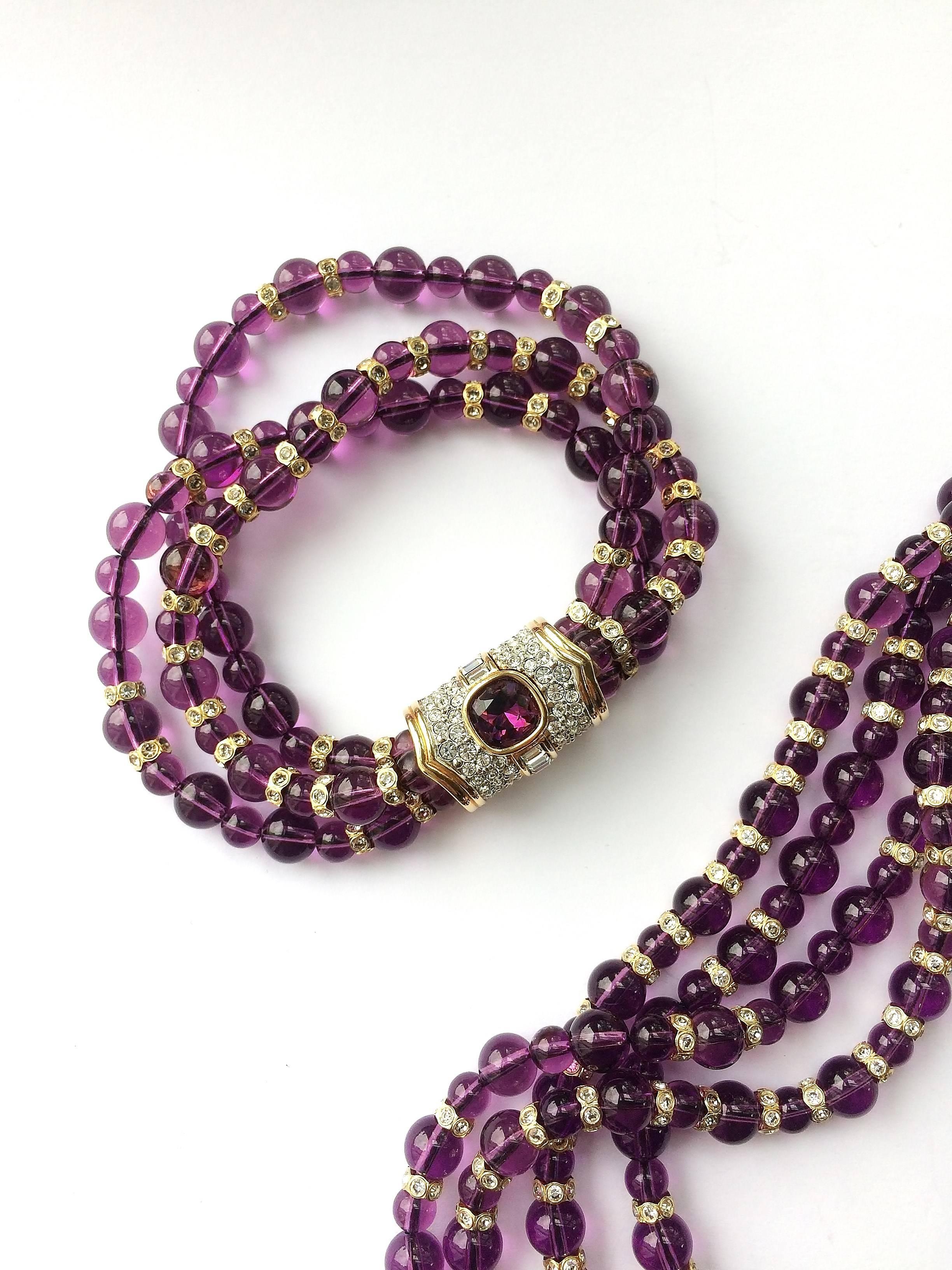 This is a wonderful set in great condition. Dark Amethyst coloured glass beads are interspaced with Swarovski crystal and gilt elements that give great light and character to the pieces and the necklace and bracelet have stunning heavily rhinestoned