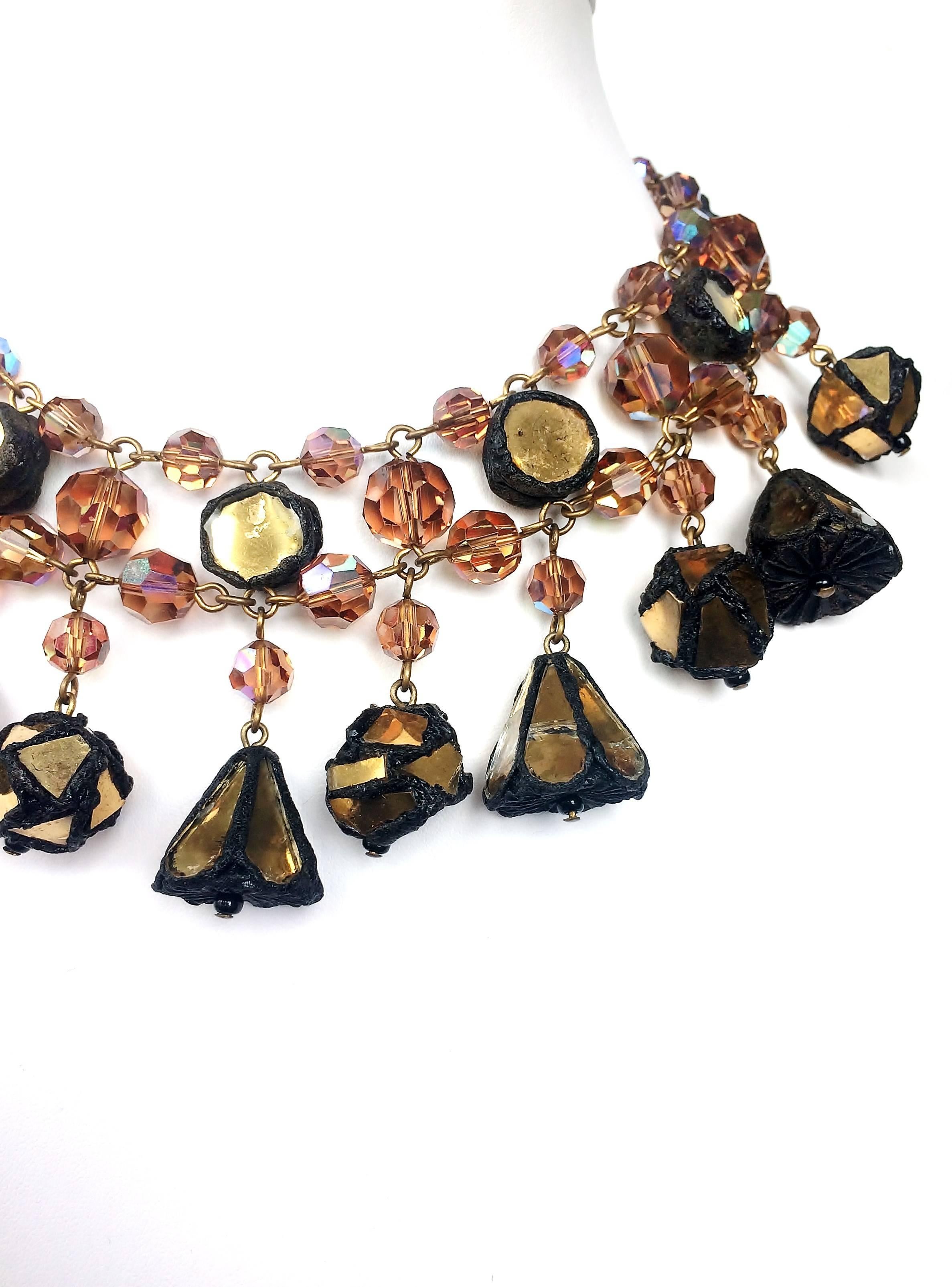 A striking and dynamic glass bead necklace, mixed with pieces of coloured mirror, set in resin (talousel), with assorted pendant drops of varying shape, from the 1960s. This design is often attributed to Line Vautrin, the celebrated jewellery
