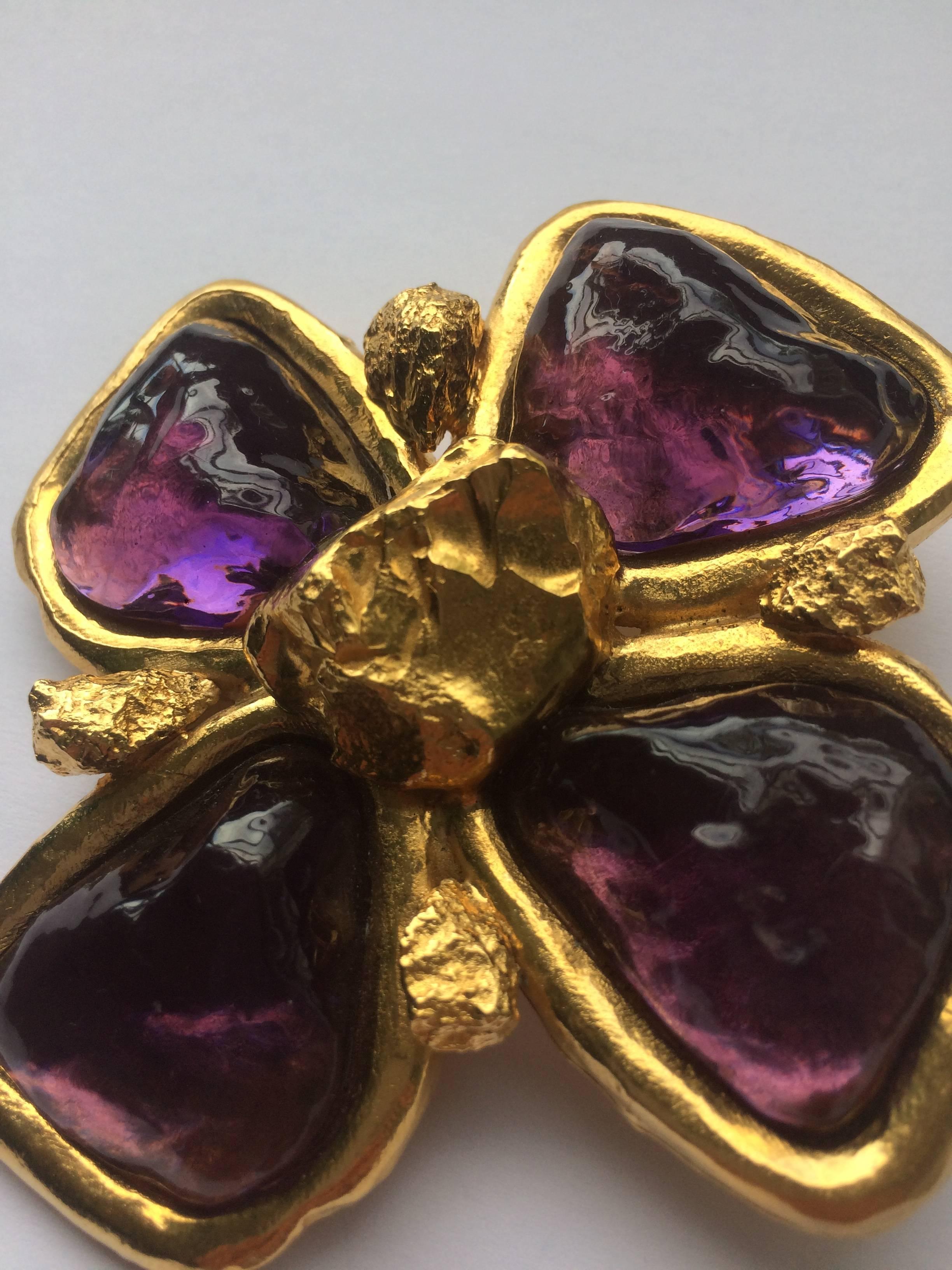 Very large gilt metal brooch with resin panels of amethyst, and gilt 'nugget' highlights. A classic design from the 1980s collections, made by Robert Goossens' atelier for Yves Saint Laurent. The brooch can also be worn as a pendant, as there is a