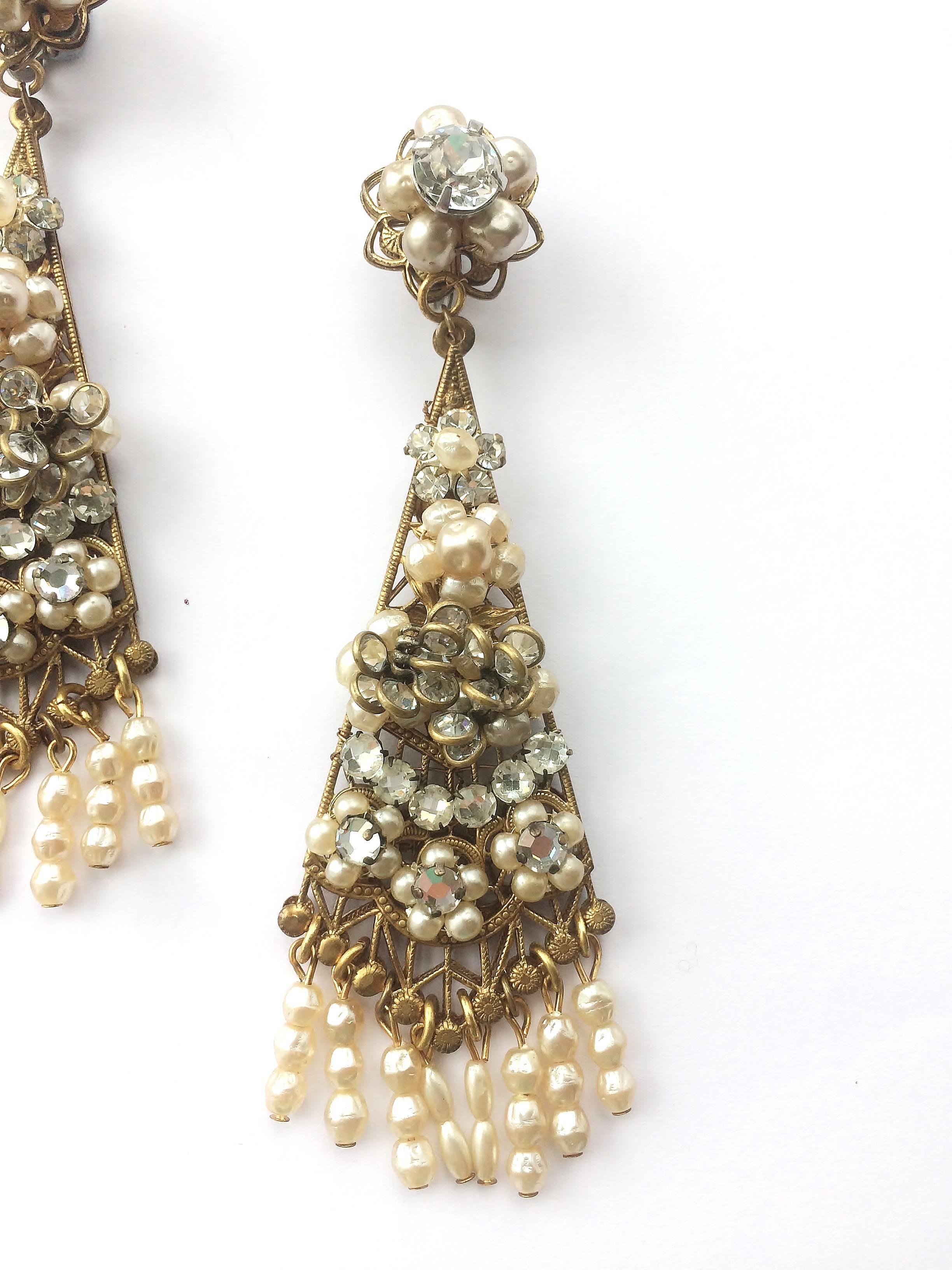 Stunning and dramatic very long 'chandelier' earrings, hand made, from the 1950s by Robert deMario. With long baroque pearl fringing and gilt filigree backing, they are very 'au courant', with this season's Spring Summer Vogue trend being