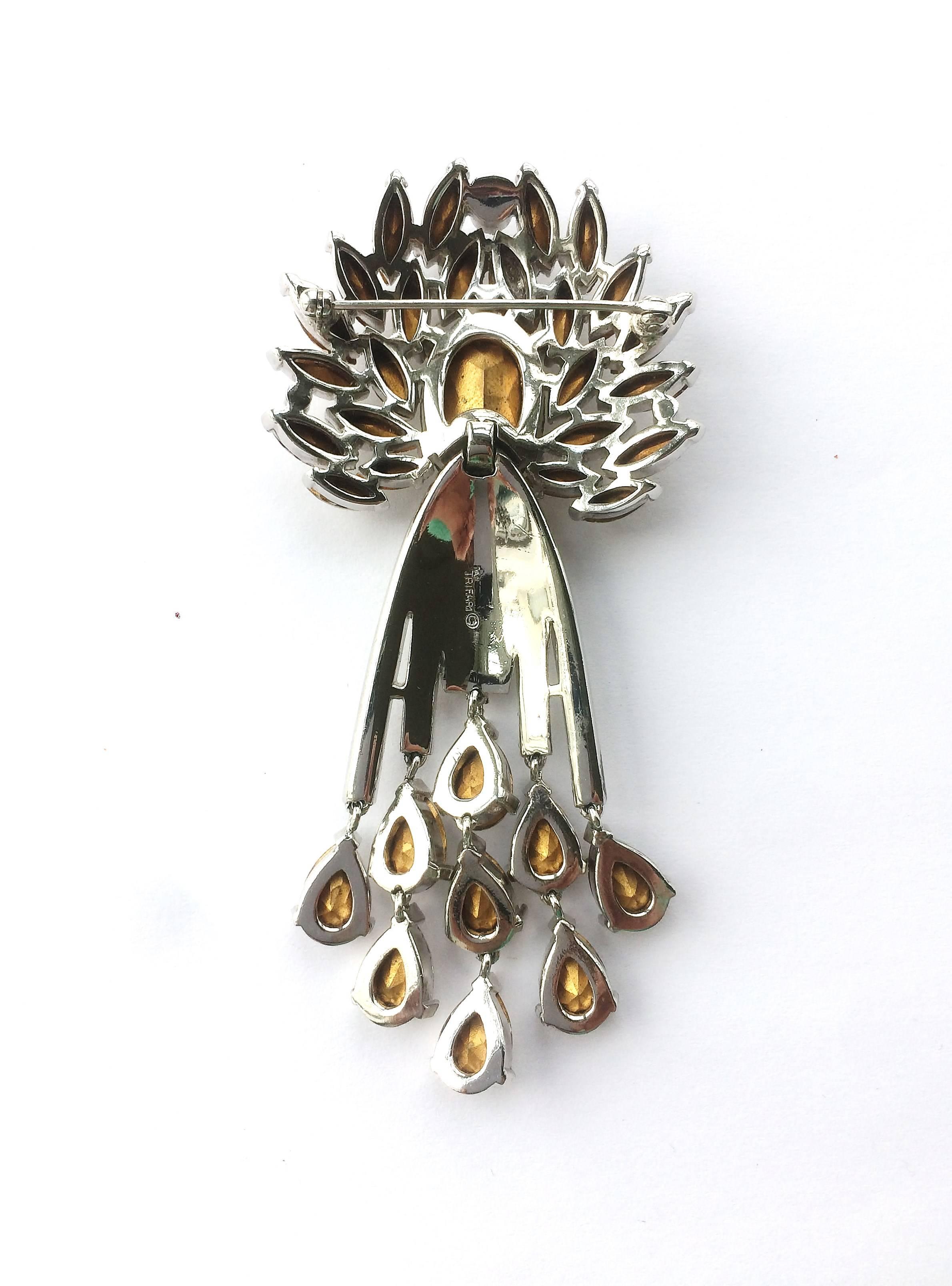 A stunning and entrancing brooch, in white paste and white paste baguettes, designed by Alfred Philippe, for Trifari, creating a classic. All the drops move and the brooch is articulated, catching the light when worn, of the highest quality and