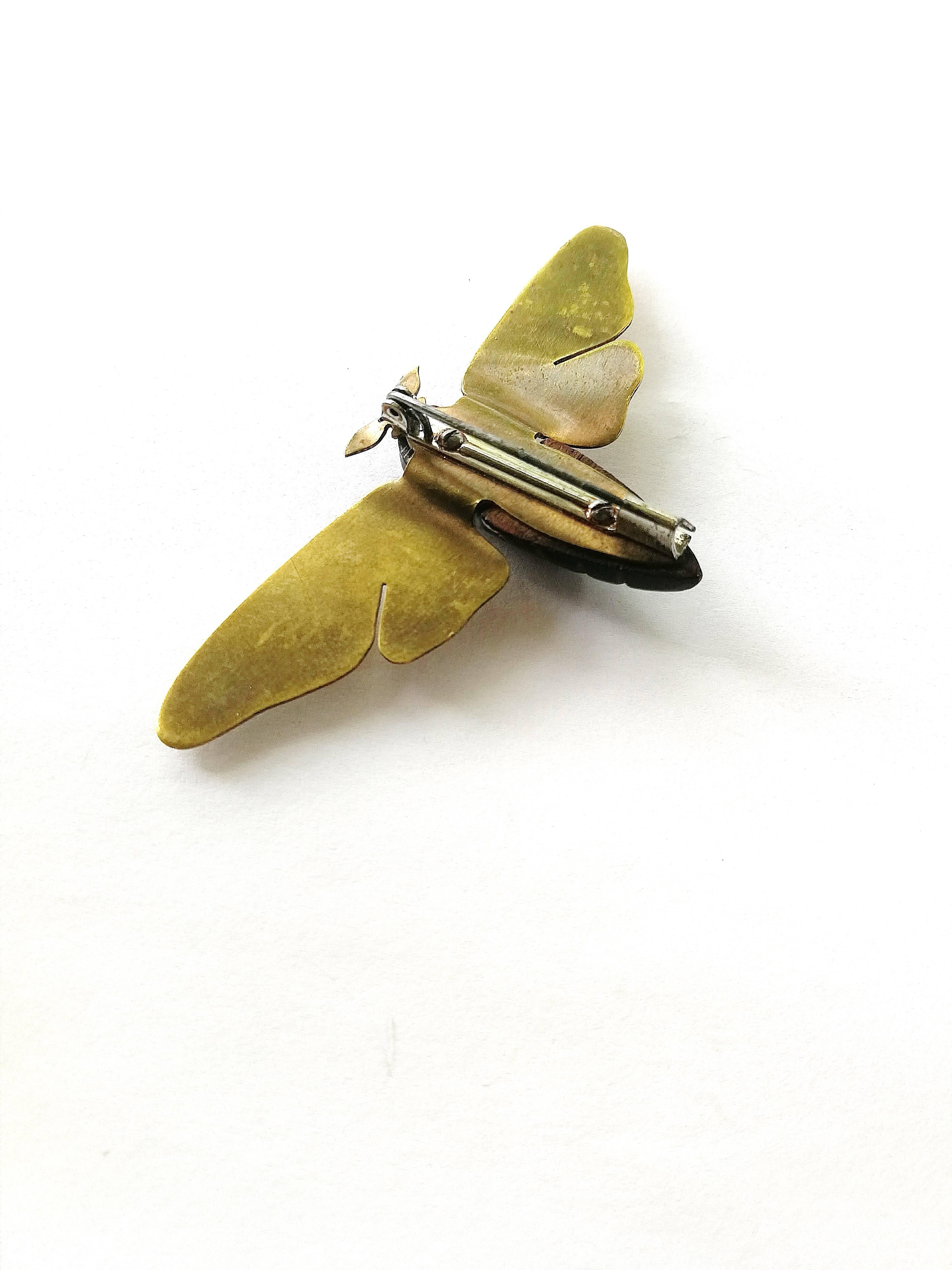 A stunning 'moth' brooch, very simple, sculpted and architectural in its design. The brass wings and ears are all one piece and engraved, the wood body, carved and polished.
It has a secure pin and hook fitting. Unsigned, it is part of a series on