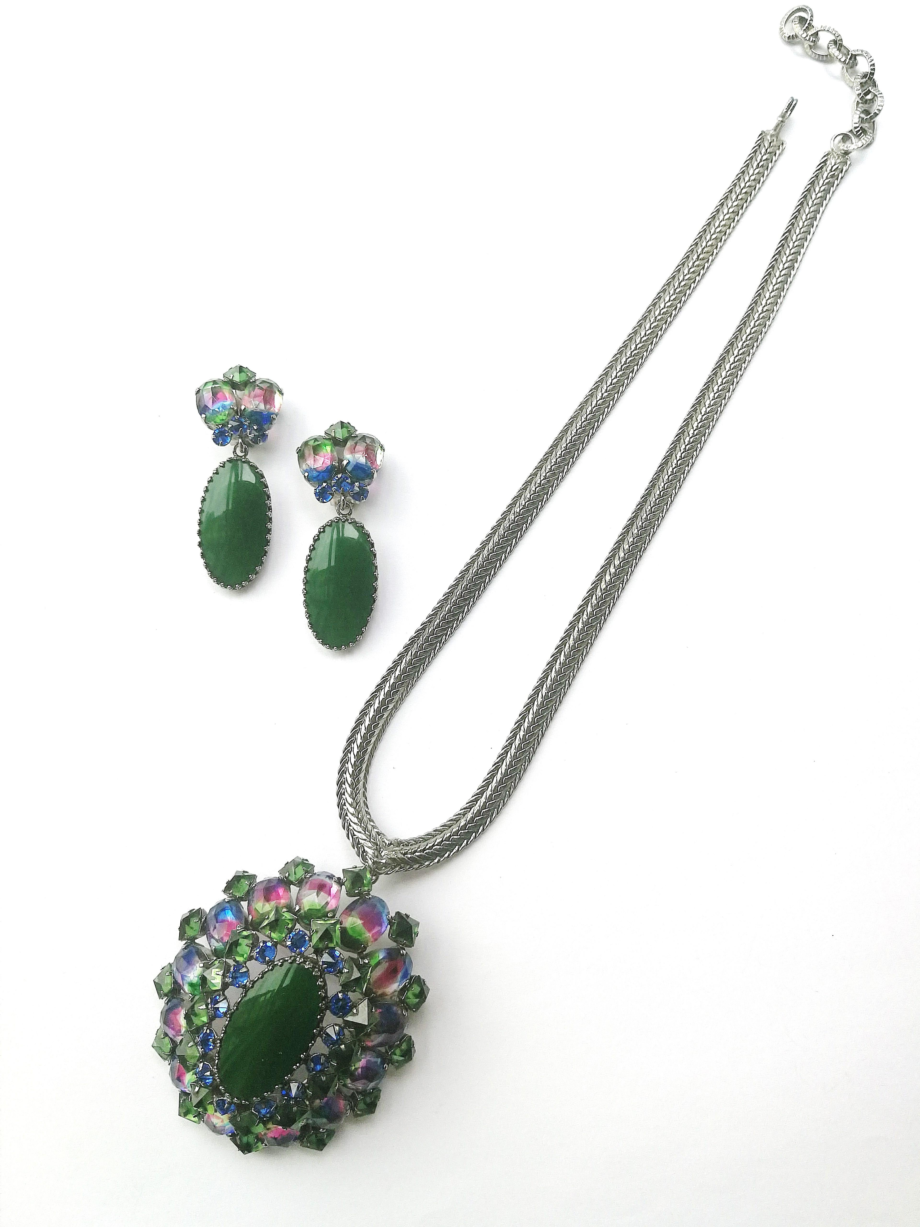A very versatile set from Schreiner of New York, the height of 1960s glamour and sophistication. A beautiful domed brooch with characteristic square upturned emerald pastes, and rainbow coloured pastes, topped by a green glass oval in the centre,