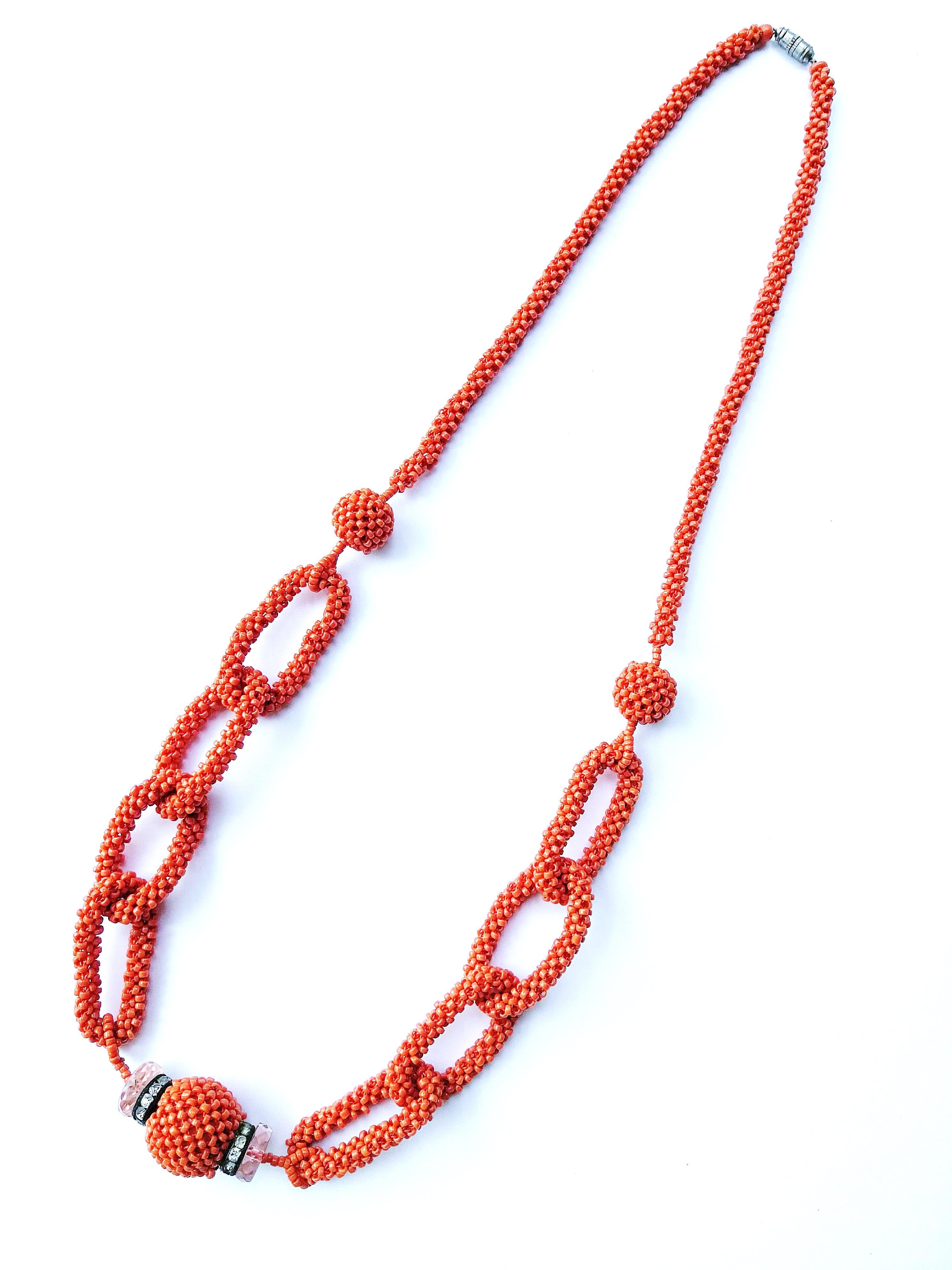 Micro beads of the most glorious colour of deep coral make up this elegant hand made  necklace, all woven into interlocking 'links', like a chain,or a single row, with a delicious 'coral' beaded ball at the front, capped with two paste rondelles and