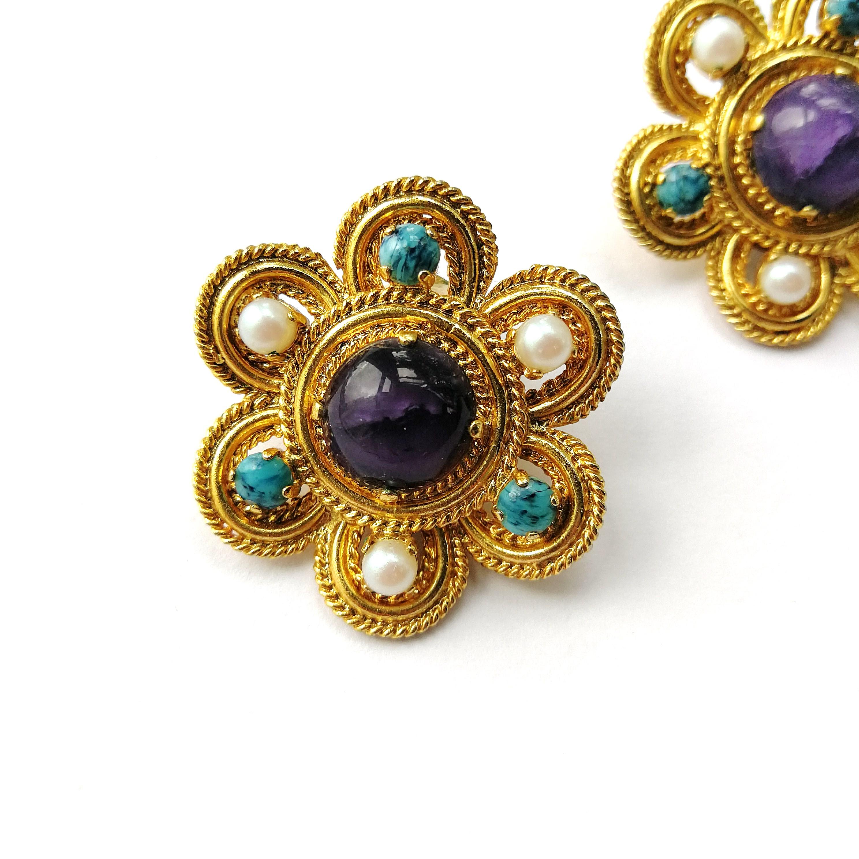 Amethyst glass cabuchons are set in gilt metal, with pearl and turquoise glass cabuchon highlights, surrounding the centre stone, reminsiscent of Byzantine jewellery, a style very much echoed in Dior's jewellery collection for 1970. (The earrings