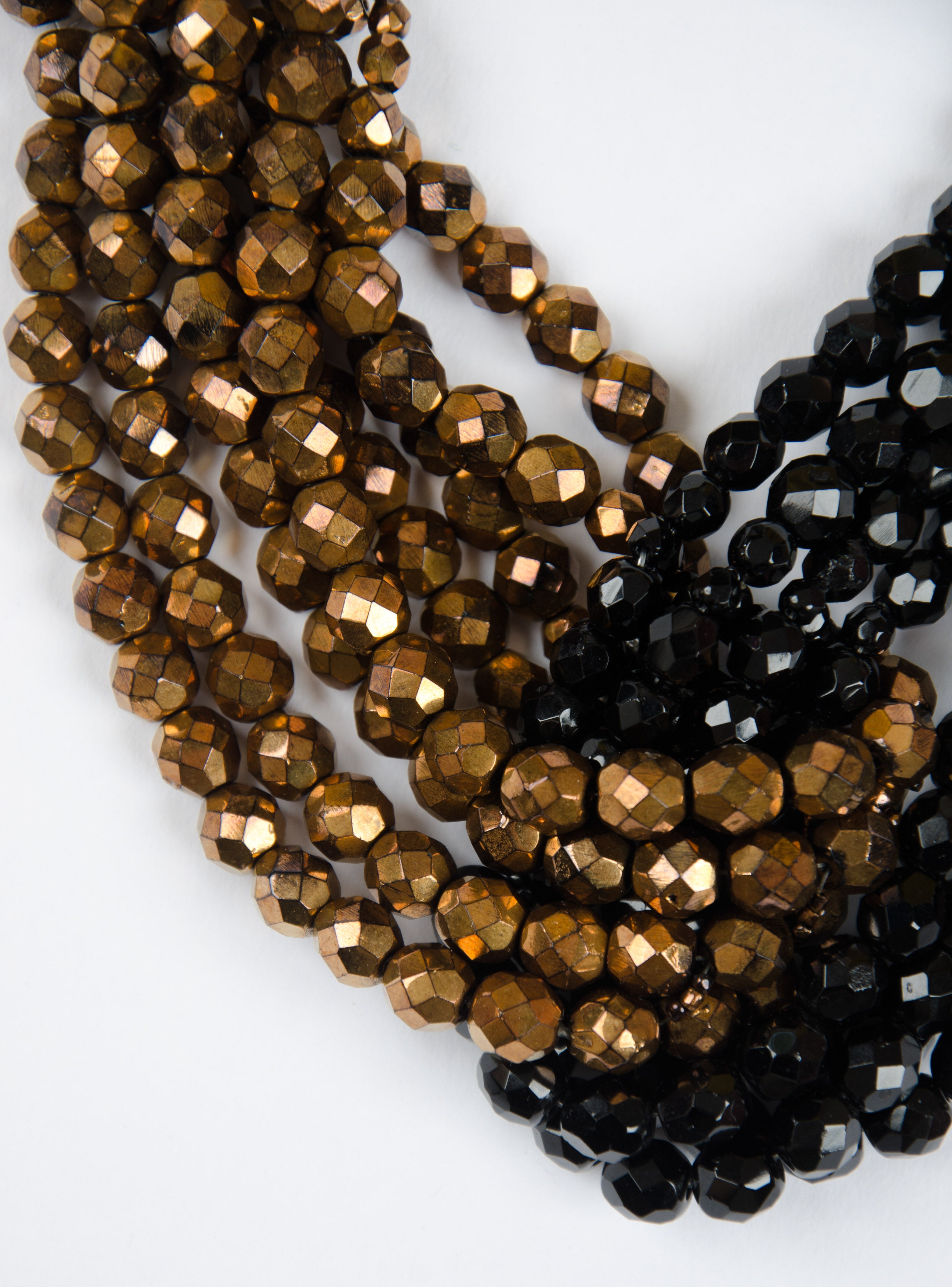 A beautiful multi row twisted necklace by Coppola e Toppo, composed of black and bronzed half crystal beads, forming an elegant 'knot' in the centre of the necklace, with compounded bead terminals at rear, with signature clasp.
Bruno and Lyda