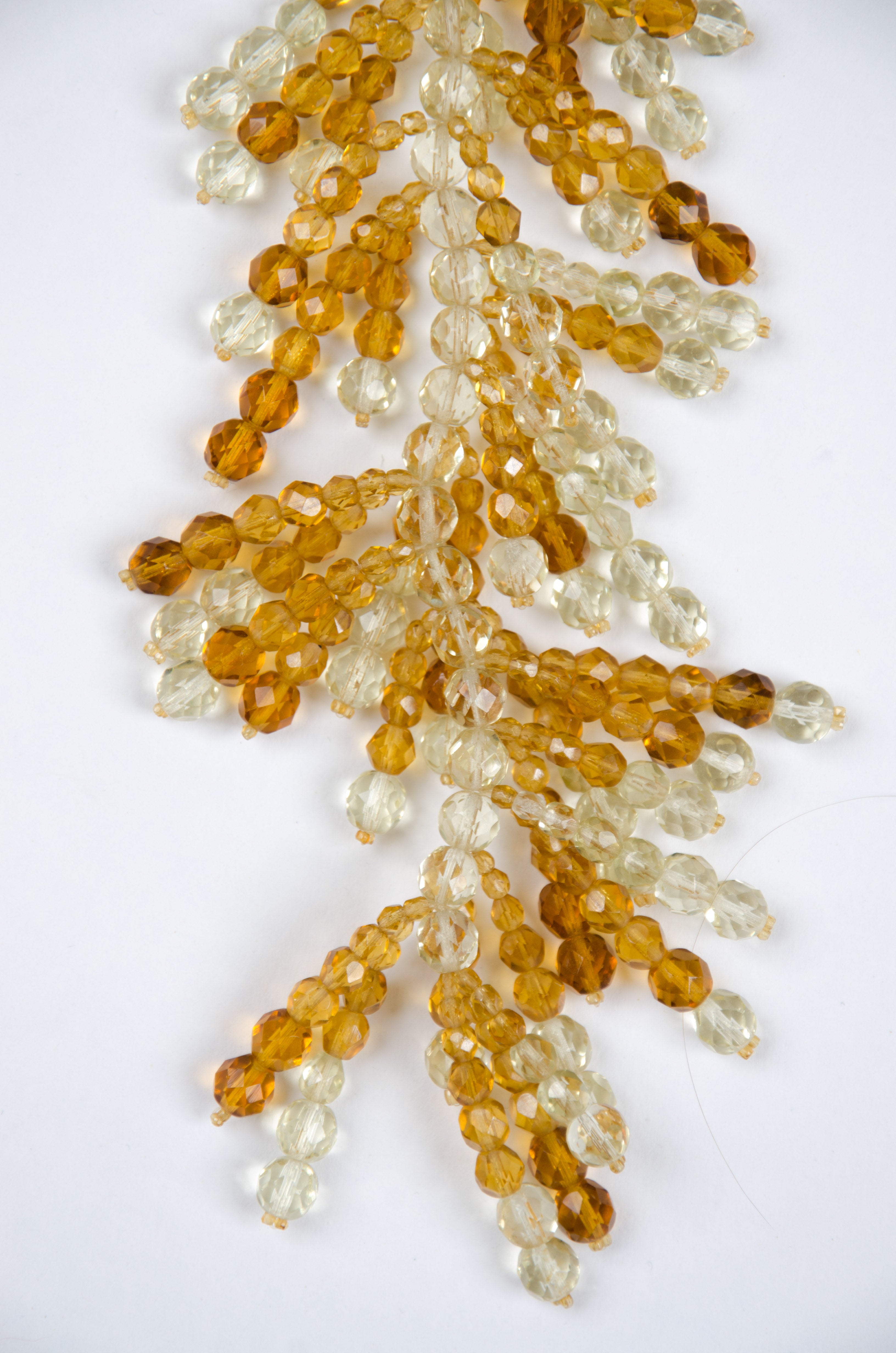 This wonderful Unsigned [no place in the design for the signature!] Lariat style amber and citrine coloured half crystal glass necklace falls beautifully in a heavy cascade of opulent beadwork.
The makers Bruno and Lyda Coppola created magnificent