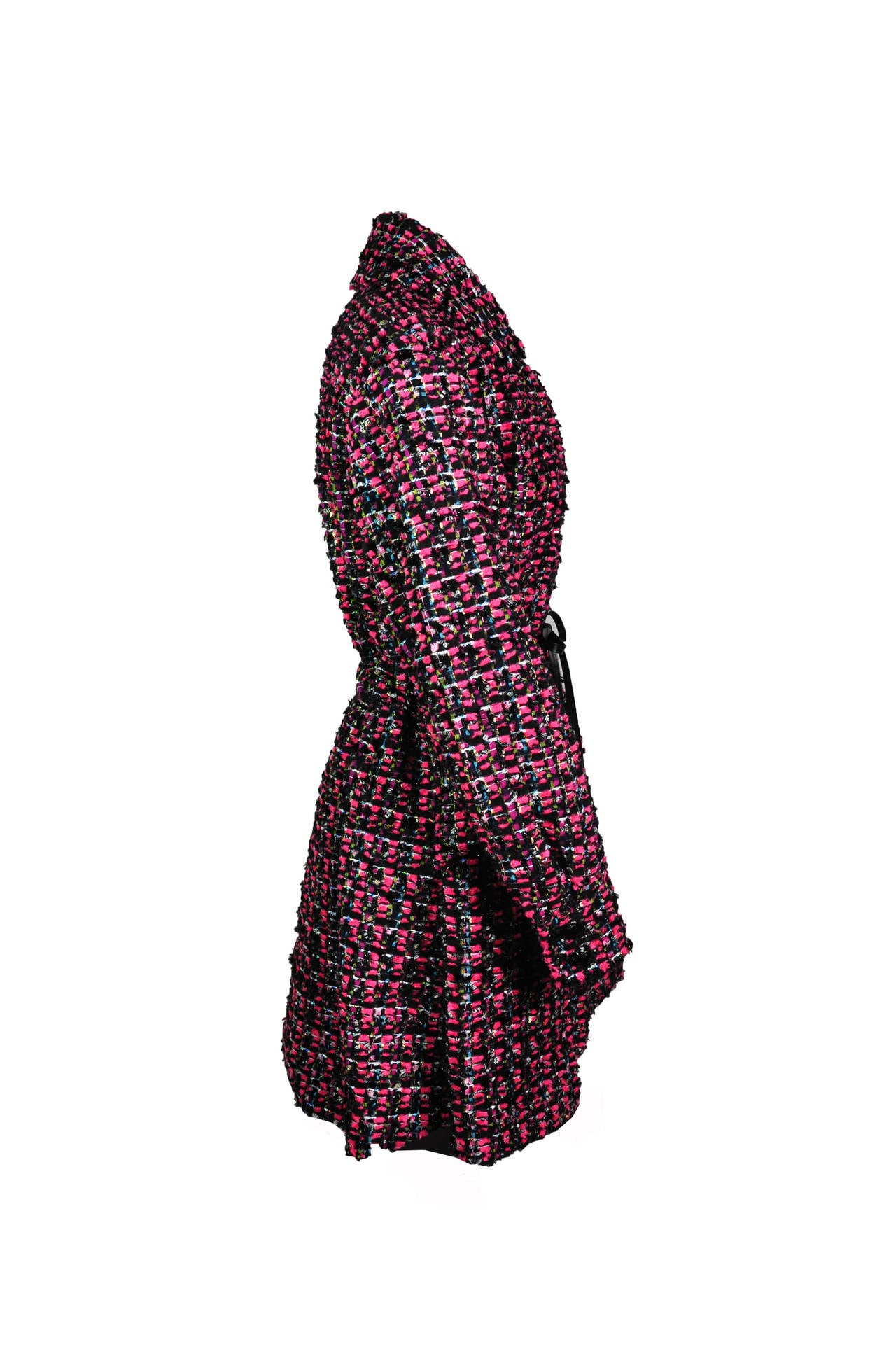 This knee length Chanel lesage tweed coat dress is in black/rose/turquoise colors.  The leather drawstring at waist together with the full and pleated skirt define well to flatter every figure. Panels in front and at back add structure and