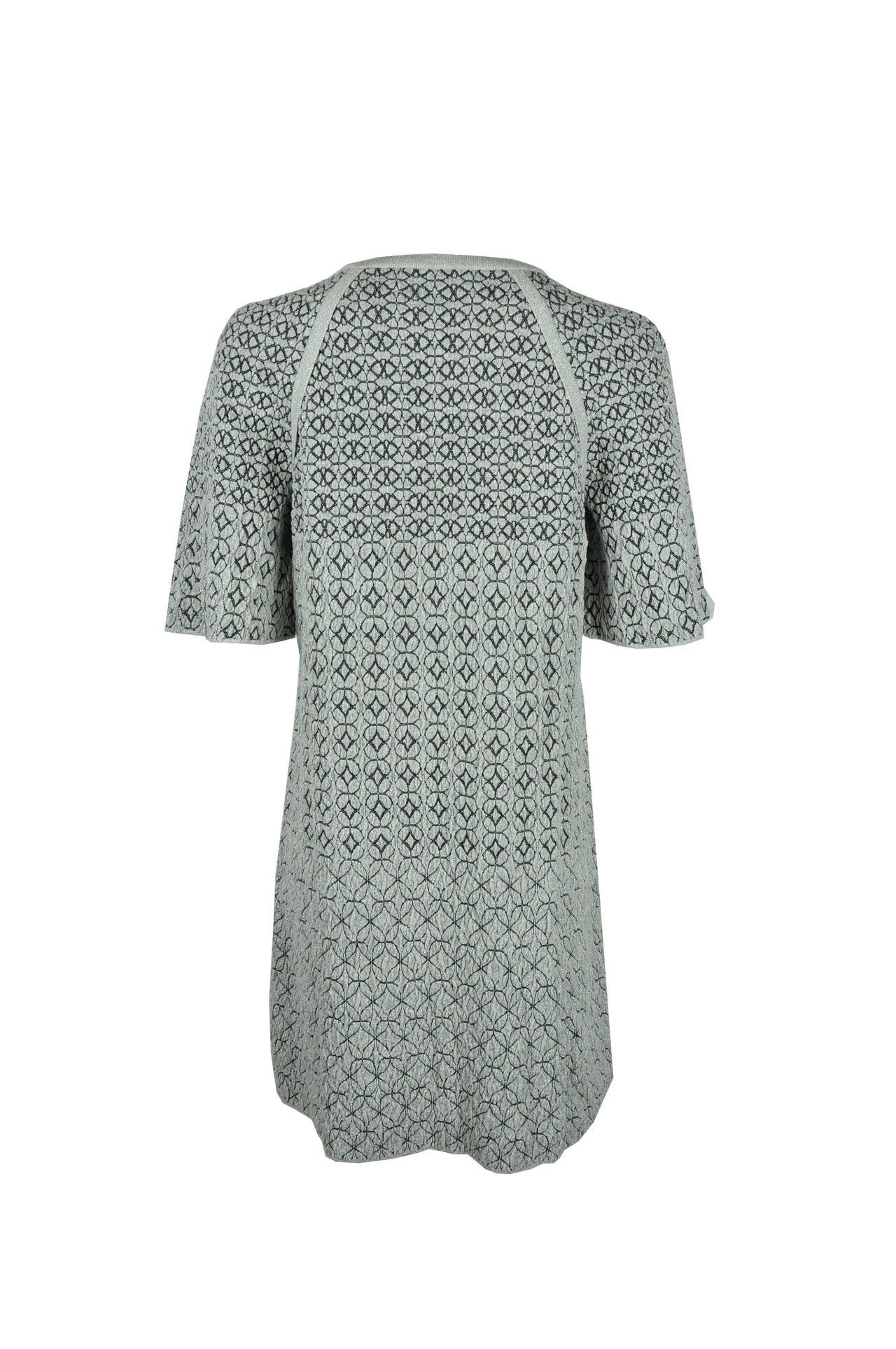 A glittering slip on Chanel graphic print jacquard knit dress features with round neck and kimono sleeves for a feminine silhouette. Two front button fastening pockets.