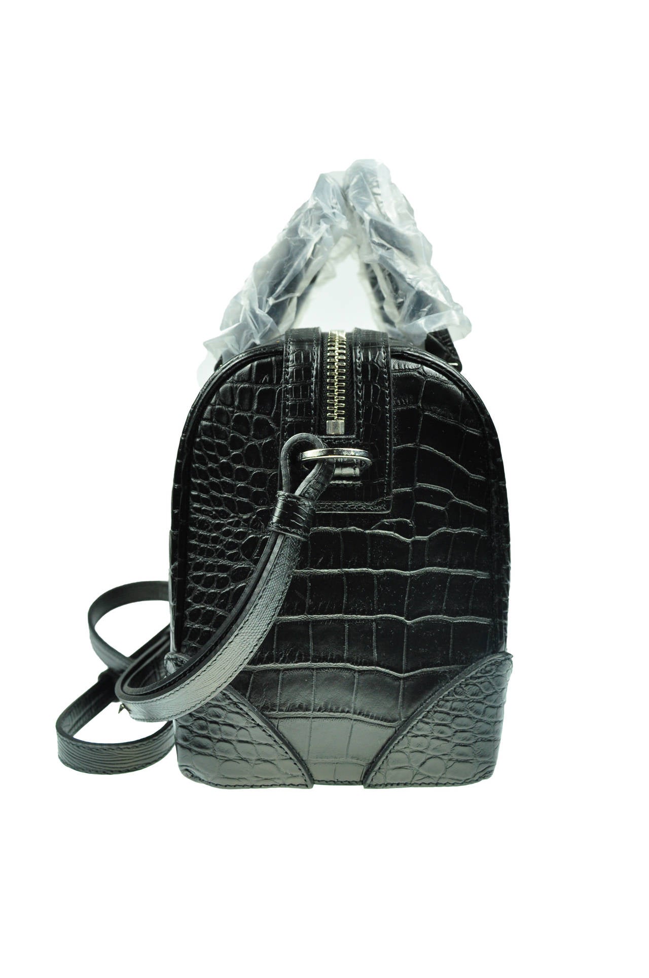 This bag is from Givenchy Lucrezia collection features with the crocodile embossed calfskin leather with canvas lining.  Adjustable shoulder strap with stubs. Zip top closure. It has one large interior zip pocket and one interior open pocket.