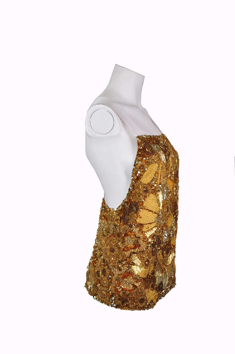 A glittering and embellished backless top which is handmade in India by artisans with ornate floral motifs constructed by gold and bronze tone silk ribbon, beads and sequins.  Fully lined.  Size fits small or medium