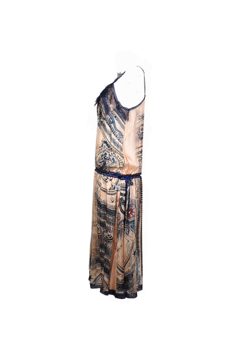 This Jean Paul Gaultier dress is beautifully crafted from lustrous peach satin silk dress with tattoo print and lace trimming. It's fluid and loose fit style makes you feel effortless to wear in summer.