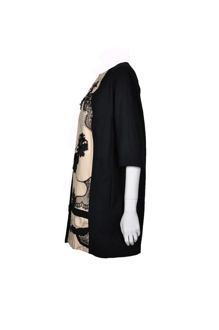A black and white cotton floral printed and embellished coat from Antonio Marras. Concealed hook fastening through front. Fully lined in cotton.