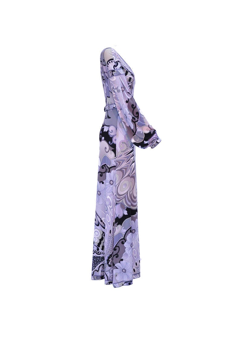 A multi-color printed low back maxi dress from Leonard, Paris in its signature silk jersey.  It has a fitted bodice and a fluid skirt with a detachable belt. Gathered button fastening cuffs with concealed zip fastening at back.