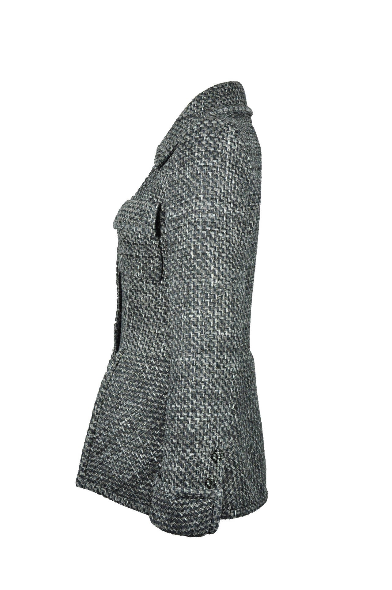 A classic and elegant fitted fantasy tweed jacket from Chanel 2015 Spring-summer collection.  It features with two front flap pockets, beautiful jeweled button fastenings through front with turned cuffs, different hemline with a back vent.  Fully